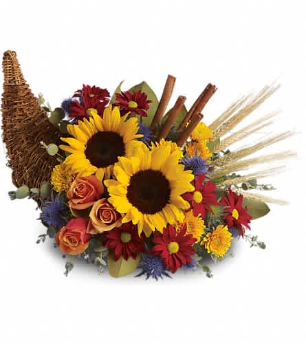 Classic Cornucopia - Along with joy this cornucopia carries an abundance of beautiful fall flowers and foliage. A stunning centerpiece or inviting entryway display this beauty will be at home anywhere in the house. Dazzling sunflowers light orange roses and spray roses red daisy spray chrysanthemums yellow cushion spray chrysanthemums eucalyptus magnolia leaves cinnamon sticks and wheat are perfectly arranged in a wicker cornucopia. Now you know why cornucopia translates to &quot;horn of plenty.&quot;Approximately 19&quot; W x 15&quot; H Orientation: One-Sided As Shown : T168-3ADeluxe : T168-3BPremium : T168-3C