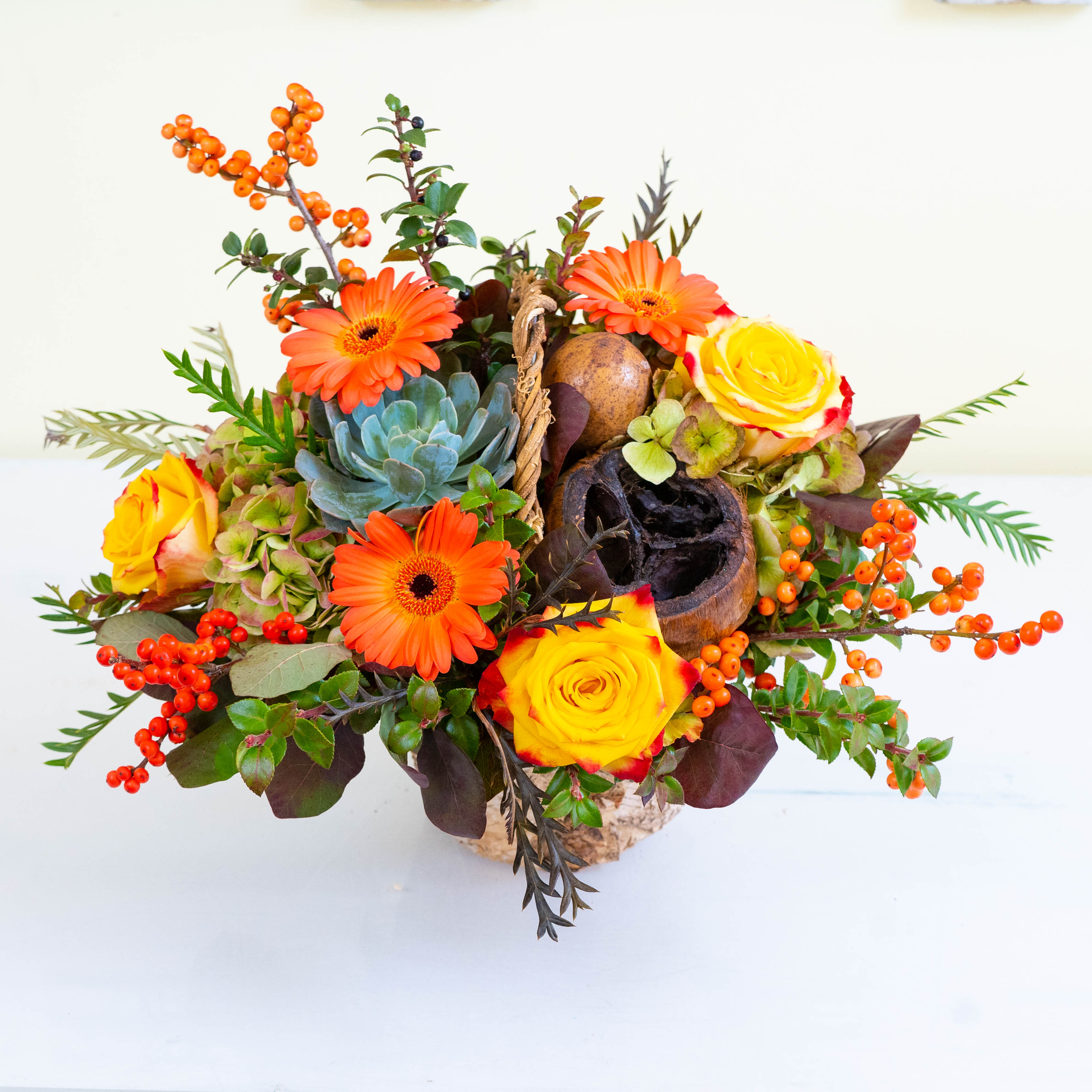 Autumn Bliss - In a white birch container, Autumn Bliss is a stunning, harvest-themed arrangement perfect for any fall holiday occasion and features many warm and verdant hues. It is embellished with dry gourds and seasonal greens. 