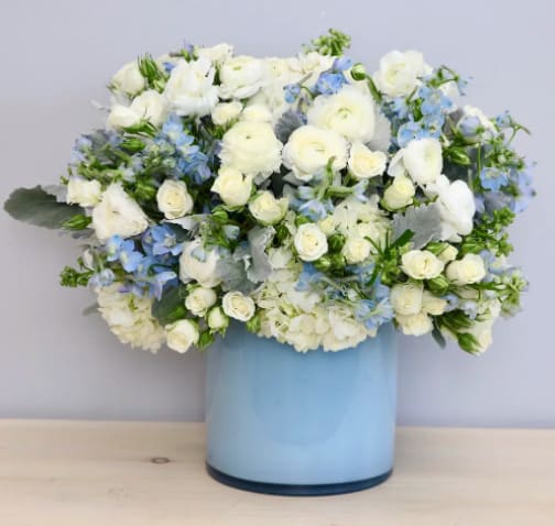 Blues Special - WeHo Blues Special - WeHo - In this blue vase we delicately arrange hydrangeas, roses, and seasonal blues hues. Standard size (pictured) is approximately 12'' tall and wide with upgrades increasing in 6'' increments.
