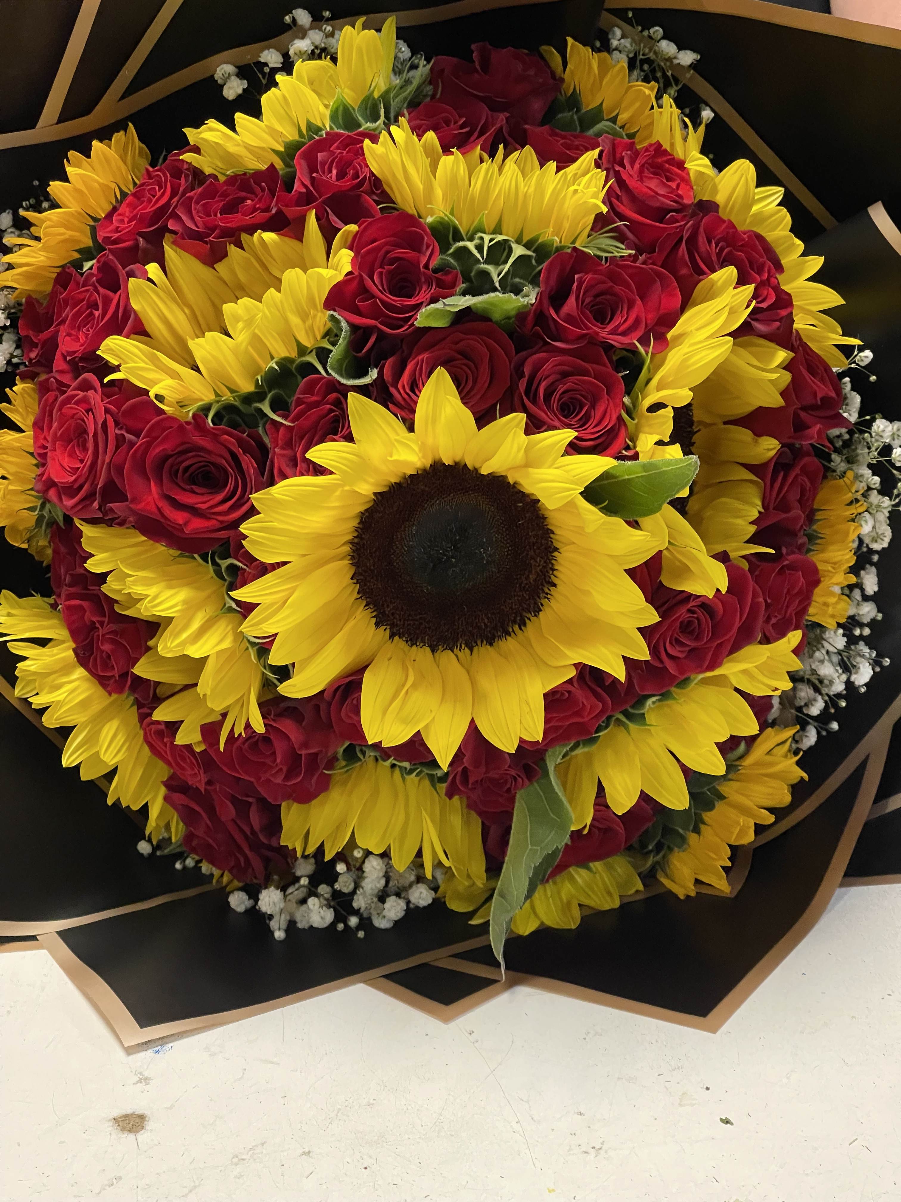 The romantic lovers bouquet  - 40 beautiful long stem roses paired with 12-14 sunflowers delicately decorated with baby breath and paired with korean wrap paper 
