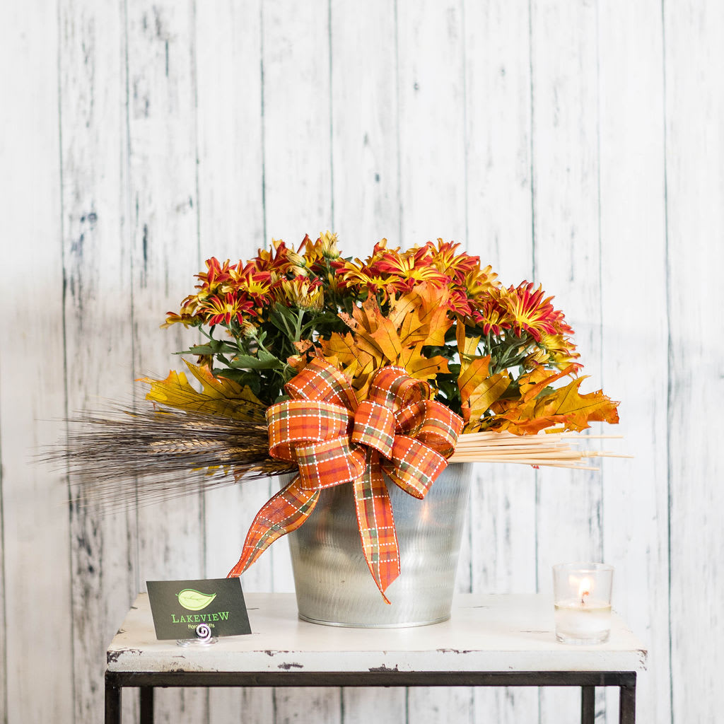 Harvest - Celebrate the season with a sunset-toned fall mum plant complete with a metal container and autumn leaf accents.   A great way to bring harvest colors indoors!