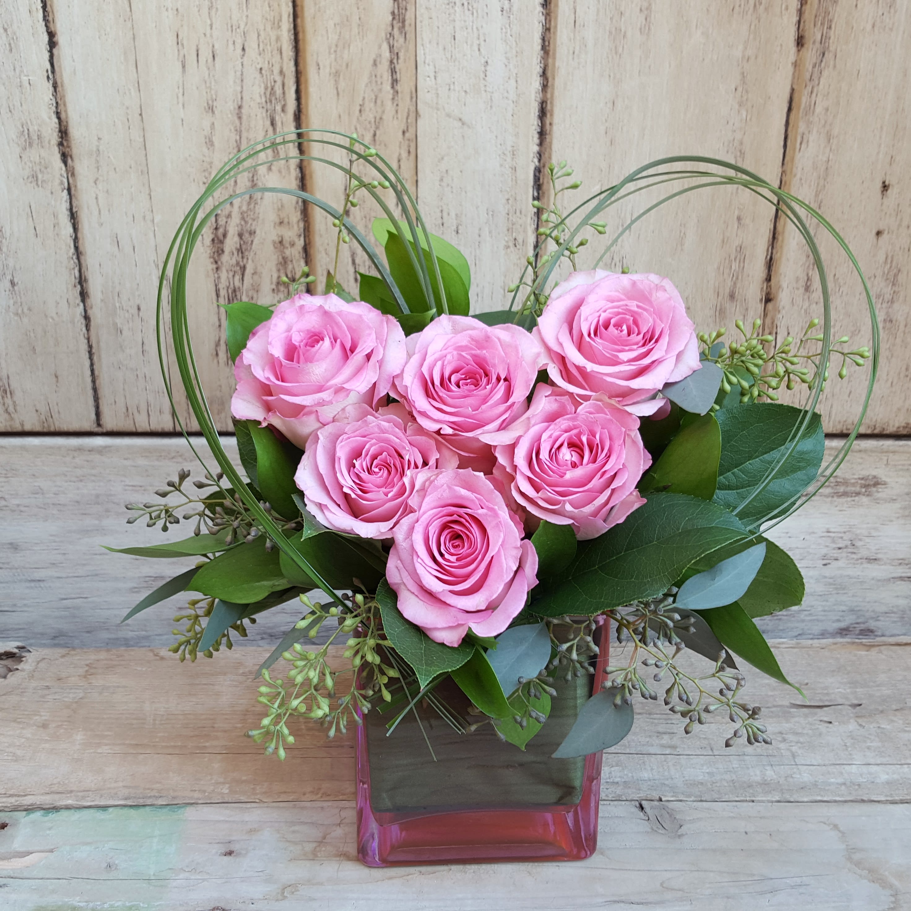 Sweetest thoughts - pink - 6 roses in a 5&quot; cube designed in the shape of a heart. Upgrades create a bigger heart of pink roses. Available in other colors please call  or email to create your custom arrangement.  Vase color will vary depending on availability. 