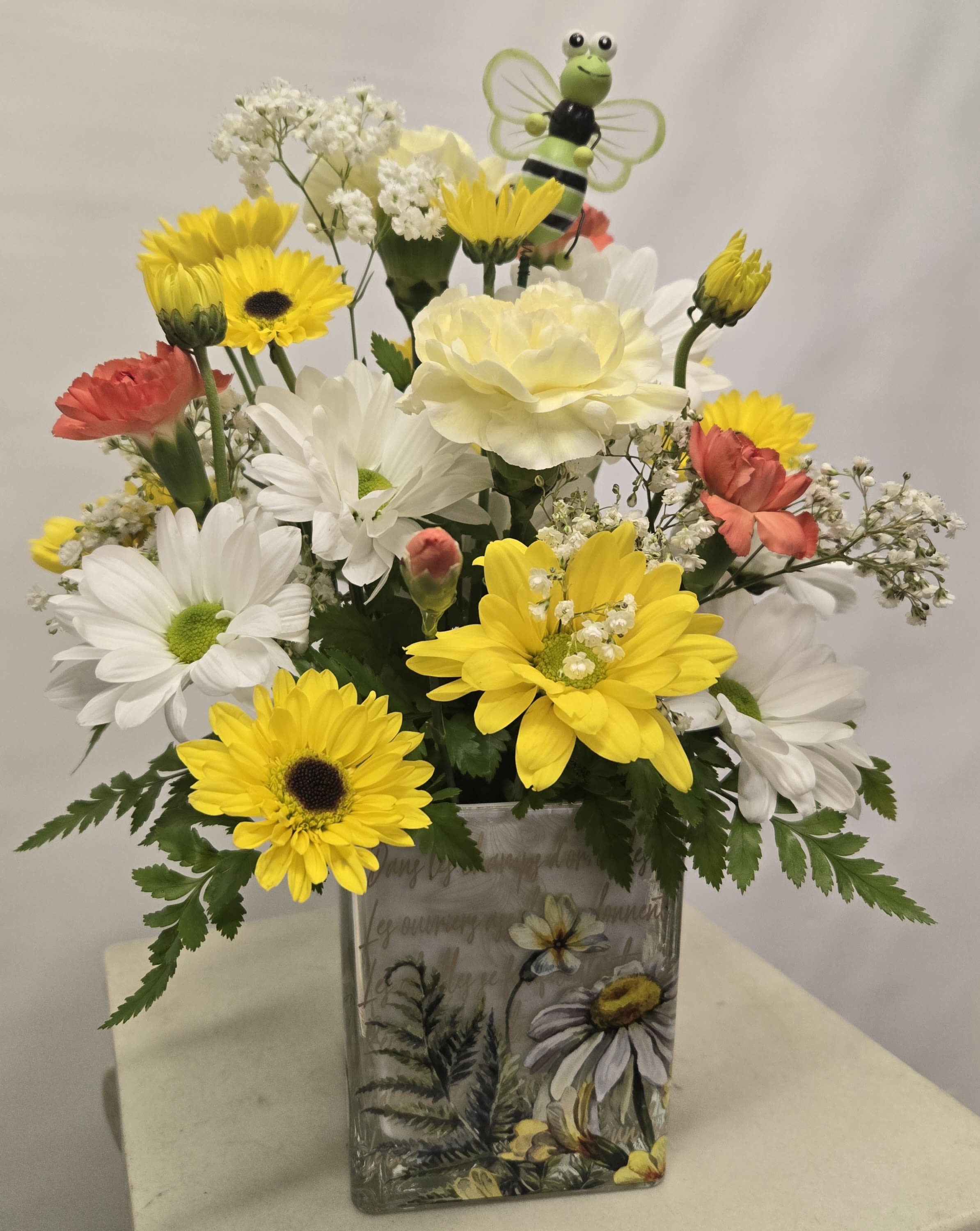 Buzzy Bee Bokay - White and yellow daisies, yellow carnations and mini carns, too, in a cute Bee cube shaped container.