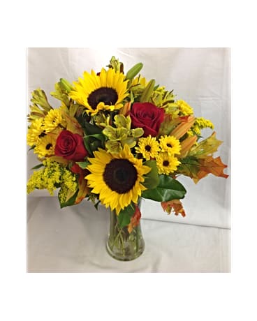 Enchanting Autumn Bouquet - In this hand arranged bouquet you see Sunflowers, Red Roses, Yellow Alstreomeria, Orange Lilies, And Buttons.  All flowers and colors are subject to change due to availability.    FCF-0285