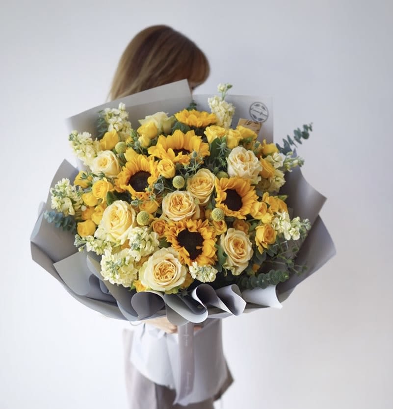 Sunshine mix bouquet  - Full of light and love is made this beautiful bouquet consisting of , yellow roses, yellow snap dragons, sunflowers, yellow poms, yellow baby roses, and a fresh and aromatic touch of eucalyptus available every day
