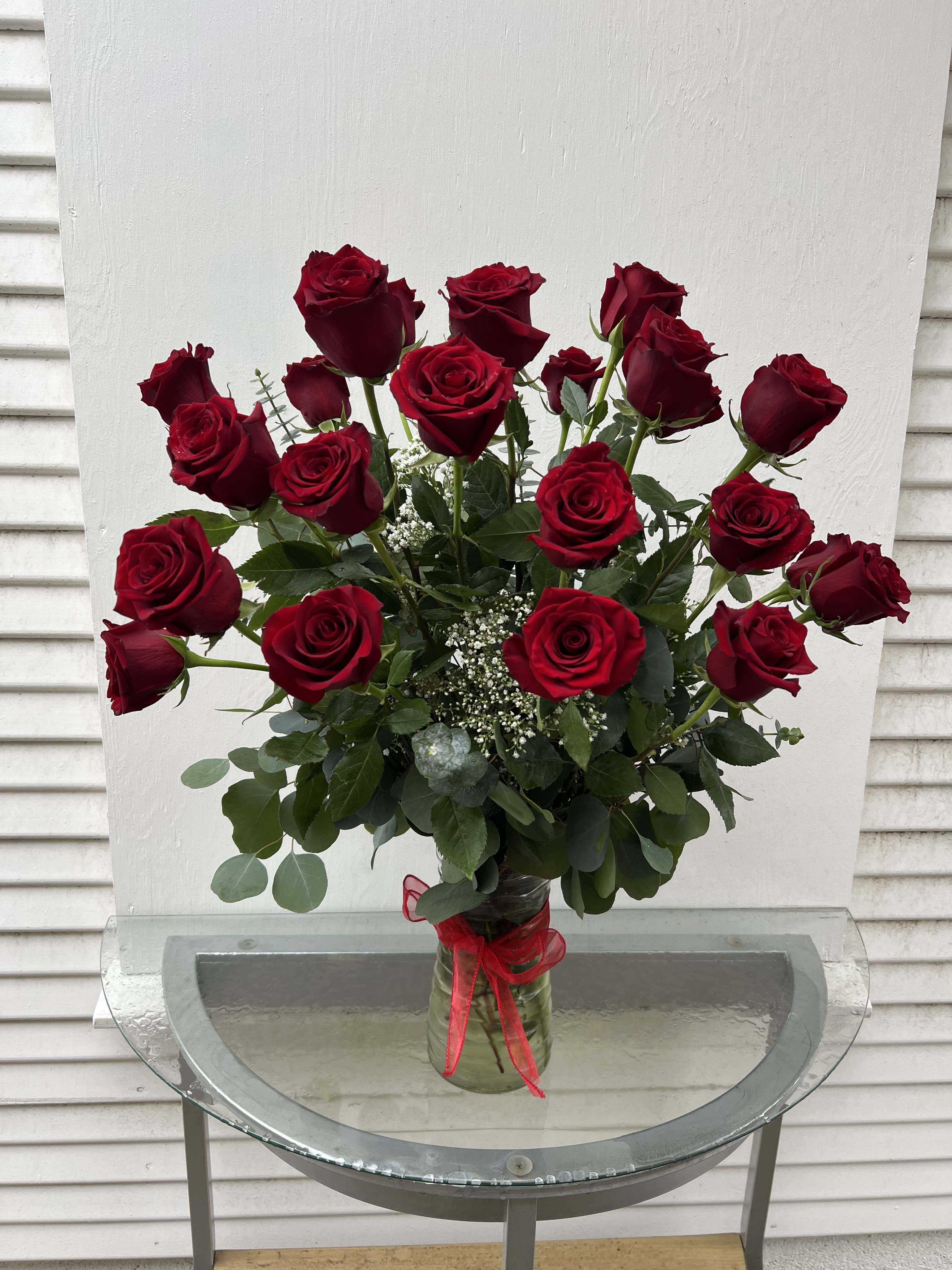 Two Dozen Red Roses - An impressive presentation of two dozen fragrant, long-stemmed red roses accented with greenery is a classic gift for Valentine’s Day, a romantic birthday, an anniversary or as a memorial tribute. It’s a traditional gift that symbolizes love. Important Note: During the summer we guarantee our roses to last 24-48 hours 