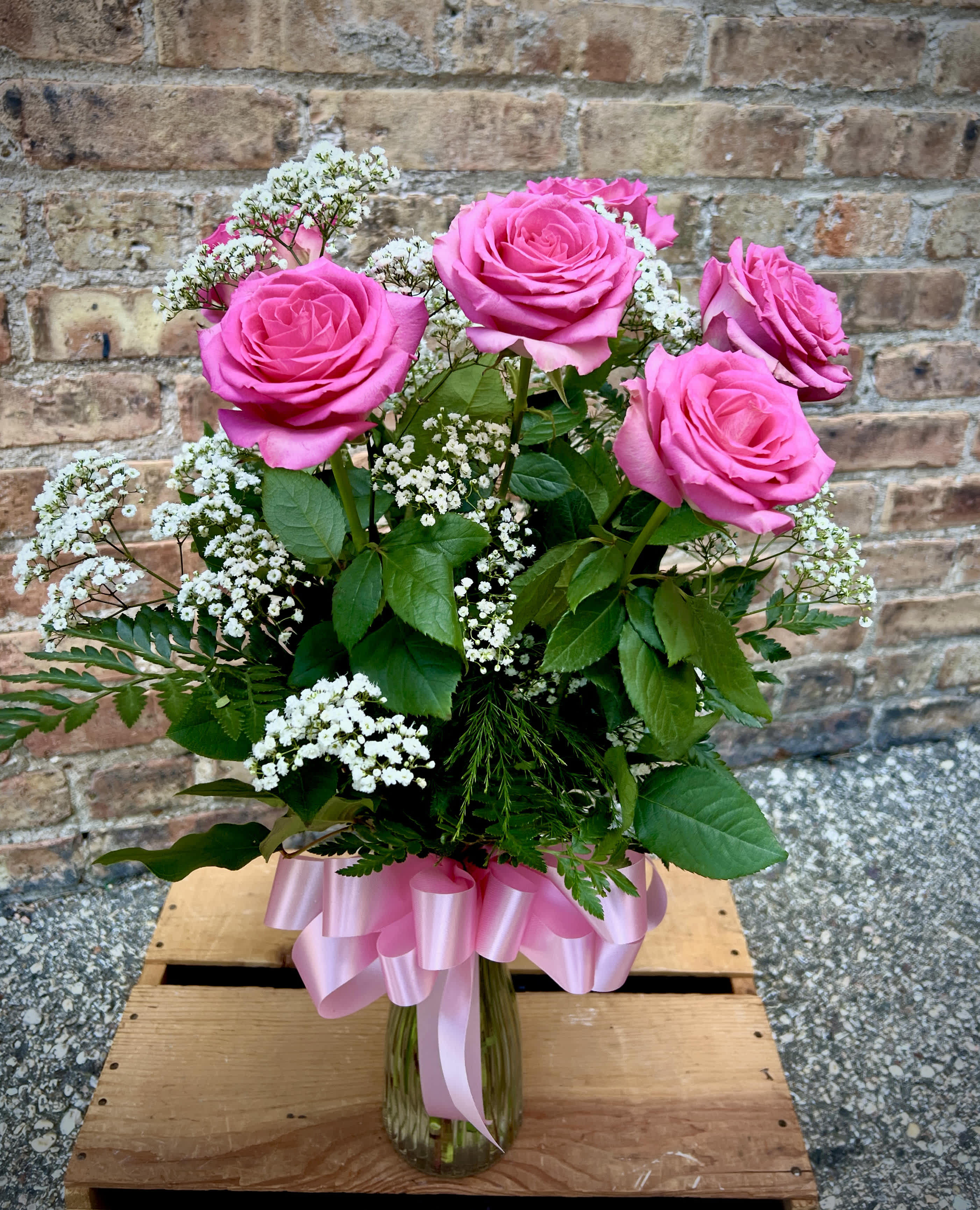 6 Pink Roses Arranged - 6 beautiful pink roses are arranged in a vase with filler flowers and greens. Shade of pink may vary from picture.  We are proud to deliver our flower creations to the Kenosha, Somers, and Pleasant Prairie area. With over 55 years of combined flower design experience in Kenosha, Wisconsin, A Summer's Garden Florist and Gifts is the perfect choice for the freshest flowers, the most creative design, and exceptional customer service.