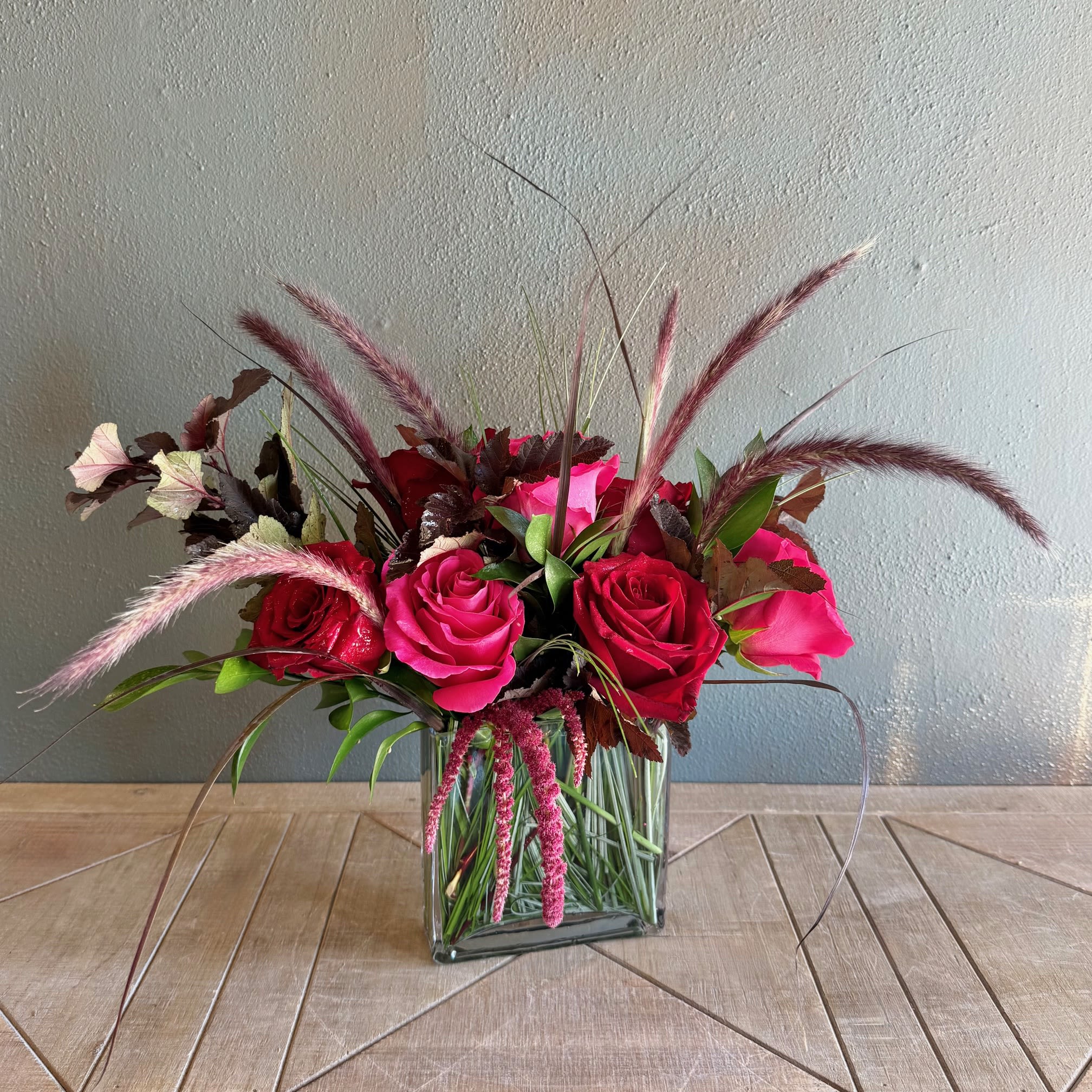 Warm and Rosy - Warm someone's heart with this beautiful modern arrangement with roses and dark foliage. 