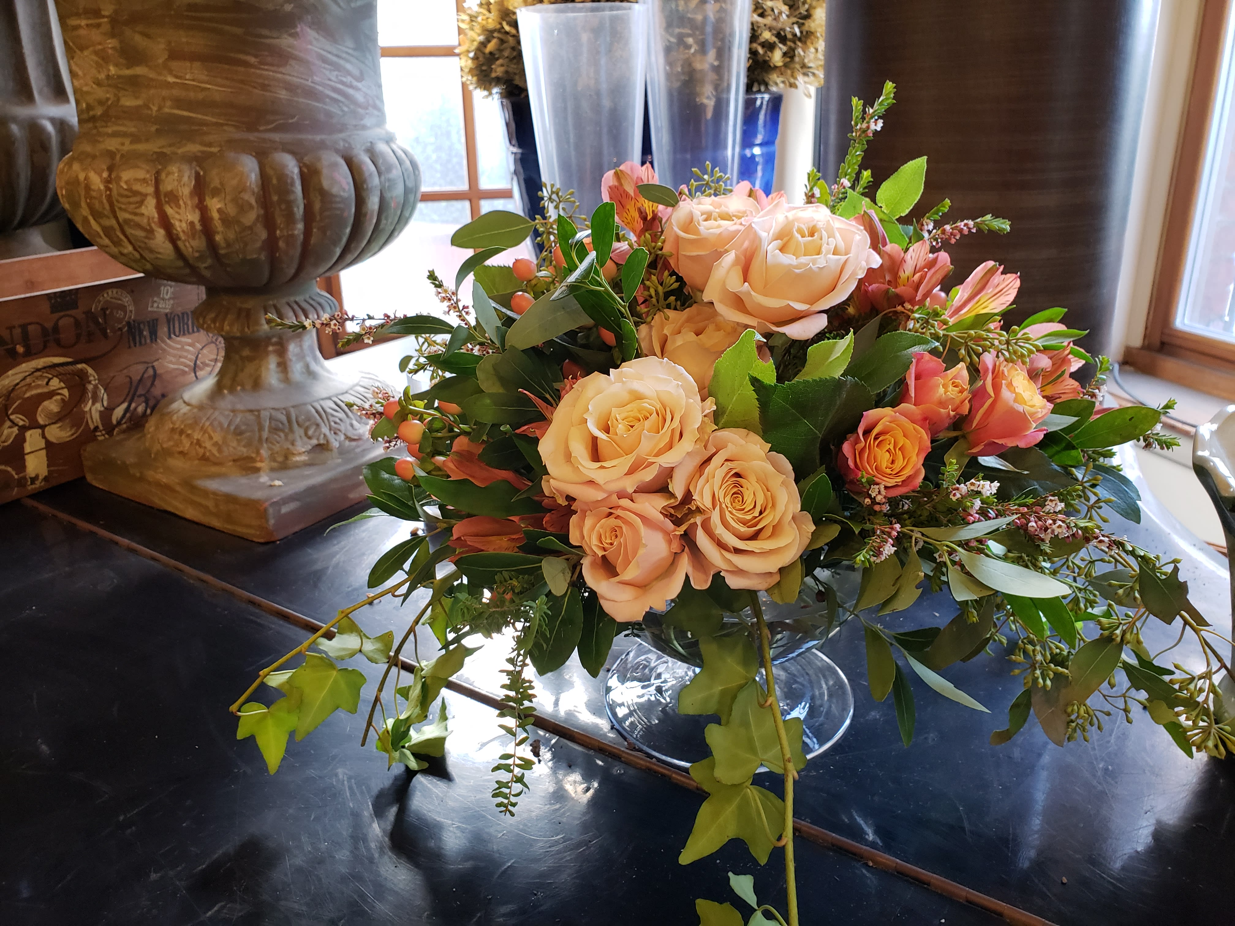 Victoria - A beautiful pedestal vase of sweet peach  and orange blossoms. 