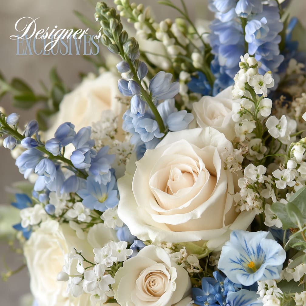 Azure Enchantment – Curated Seasonal Arrangement in Shades of Blue - Step into a world of tranquil beauty with Azure Enchantment, a couture floral design inspired by the timeless elegance of blue. This Curated Seasonal Arrangement features the finest blooms in shades of sapphire, sky, slate, and deep indigo, evoking serenity, sophistication, and quiet emotion.  Each composition is a one-of-a-kind expression of artistry, thoughtfully designed by our expert team using premium seasonal flowers sourced from our trusted growers. The result is a fluid and romantic arrangement that feels modern yet deeply soulful.  Whether you're marking a moment of sympathy, celebration, or deep appreciation, Azure Enchantment offers a refined and rare floral experience from DeLand’s premier luxury florist.  Design Style: Loose, airy, layered Mood: Serene, elegant, introspective Floral Content: Curated Seasonal Arrangement, specific flowers will vary to reflect the best available blooms in blue-toned hues  Available for delivery and pickup throughout Central Florida, including DeLand, Lake Mary, Sanford, Winter Park, and surrounding cities.  By Appointment Only All arrangements are made to order, ensuring exclusive, white-glove floral service for each client.
