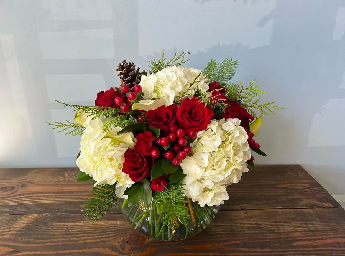 Holiday Bouquet Holiday Bouquet - Red, white green arrangement that will put a smile on someone’s face this holiday season. Place your Order Online Monday to Saturday before 1:00 p.m. (E.T.) for same-day delivery. “Orders received after hours will be delivered the next business day”. Check our coverage area. Occasionally, flowers and/or container substitutions happen due to weather, seasonality, and market conditions, which may affect availability. If this is the case with the gift you’ve selected, we will ensure that the style, theme, and color scheme of your arrangement are preserved and will only substitute items of equal value or higher value. CARE INSTRUCTIONS Keep the flower arrangement hydrated with natural water and change the water every two days. Do not spray any cleaning product on the flower arrangement. Do not place heavy objects directly on the flower arrangement. Keep flower arrangements out of direct sunlight and extreme heat.