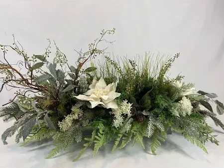 Wild Christmas Centerpice Wild Christmas Centerpice - Simply unique! This gorgeous winter green and white design is artfully hand-designed to be an incomparable centerpiece. Place your Order Online Monday to Saturday before 1:00 p.m. (E.T.) for same-day delivery. “Orders received after hours will be delivered the next business day”. Check our coverage area. Occasionally, flowers and/or container substitutions happen due to weather, seasonality, and market conditions, which may affect availability. If this is the case with the gift you’ve selected, we will ensure that the style, theme, and color scheme of your arrangement are preserved and will only substitute items of equal value or higher value. CARE INSTRUCTIONS Keep the flower arrangement hydrated with natural water and change the water every two days. Do not spray any cleaning product on the flower arrangement. Do not place heavy objects directly on the flower arrangement. Keep flower arrangements out of direct sunlight and extreme heat.