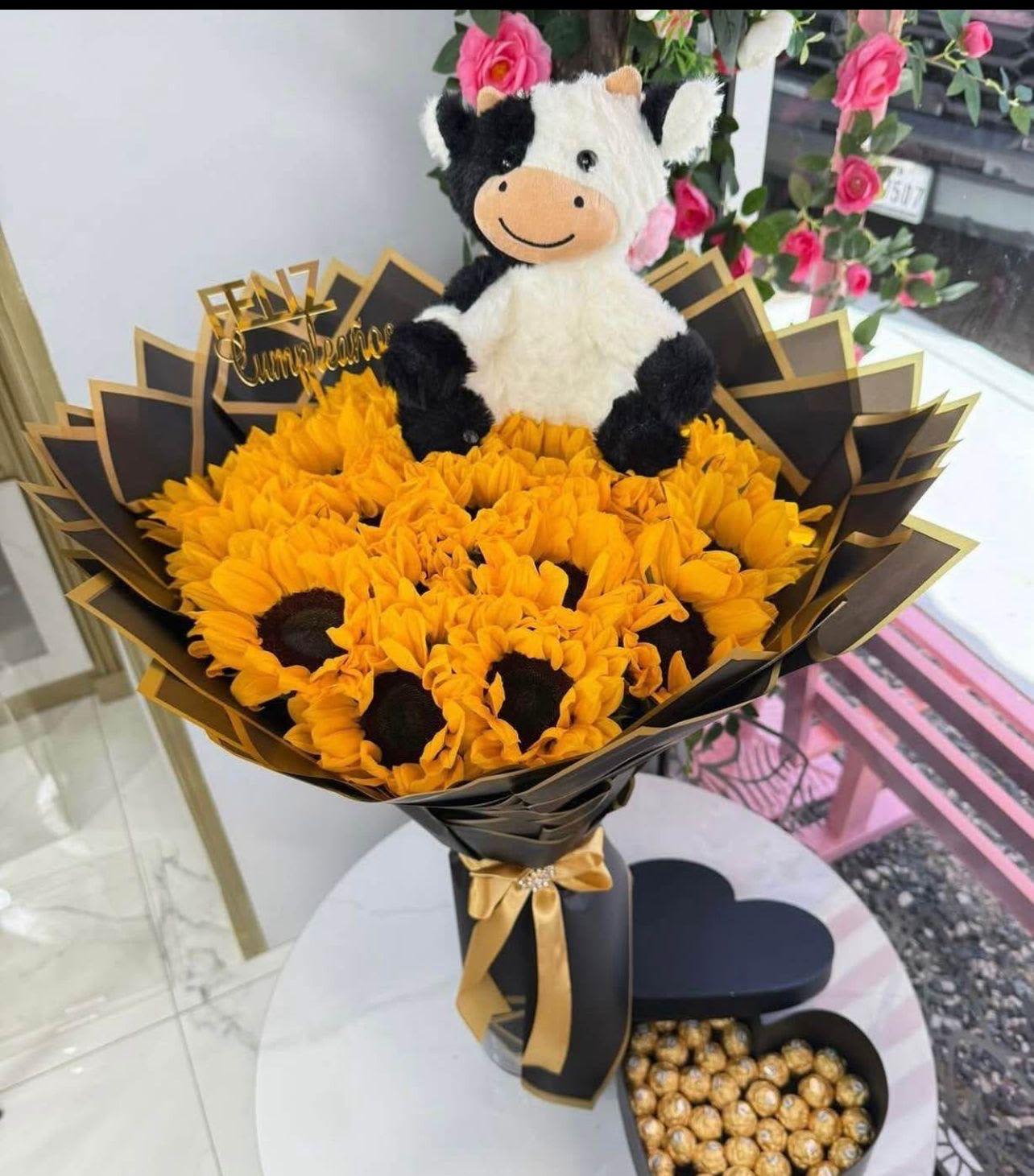 Ramo de girasoles y vaquita - Ramo elaborado con girasoles, peluchito de vaquita y papel color negro.