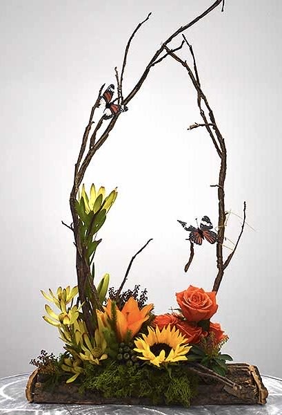 Walk in the Woods Walk in the Woods - Let take a Walk in the Woods, surrounded by twigs and branches, a few butterflies and a soft carpet of a couple roses, a single lily and sunflower combined with sunset safari and moss in a tree branch cut out. Perfect for the nature lover in everyone. Bring the quiet of nature into your space with this awesome design.