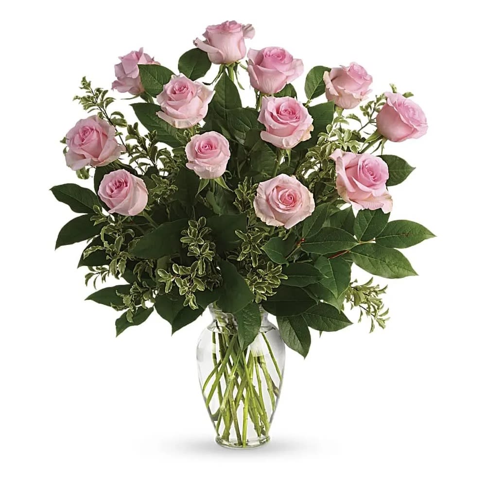 Say Something Sweet Bouquet - Say it sweeter with this feminine bouquet of pink roses and lush greens in a graceful glass vase. Pink roses are arranged with pitta negra and lemon leaf. Delivered in a clear glass vase.
