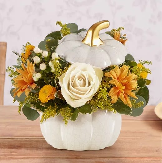 The Plentiful White Pumpkin - A plentiful mix of blooms gives our autumn arrangement an undeniable charm. Loosely gathered in cream and fall tones, it’s the perfect contrast to our modern-styled pumpkin. Featuring a white satin finish, crackle detail and rich golden accents, this harvest-inspired container is perfect for repurposing.
