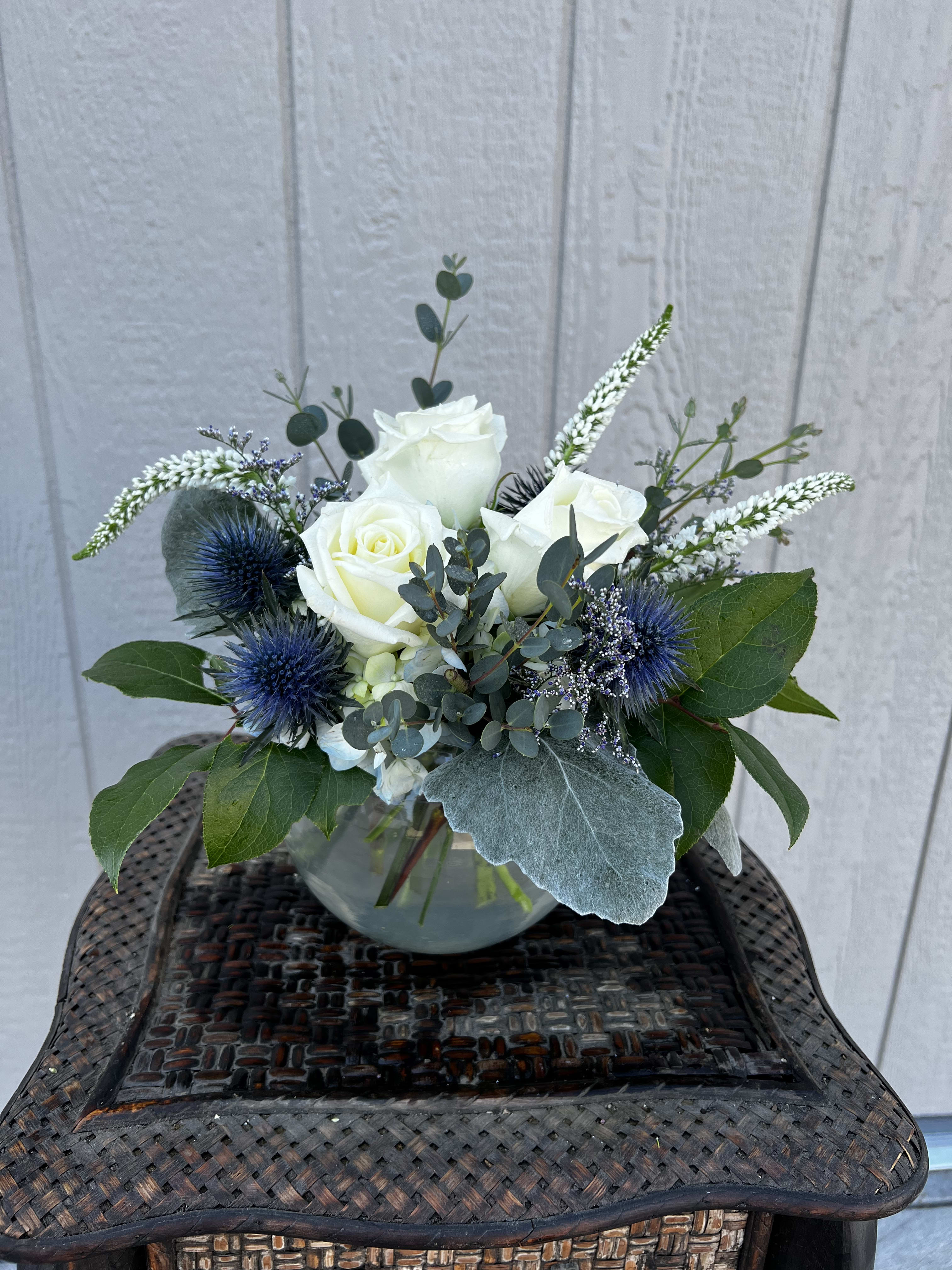 Wave of Love  - A thoughtful arrangement put together with blue hydrangea, thistle, veronica, white roses, and greenery. 