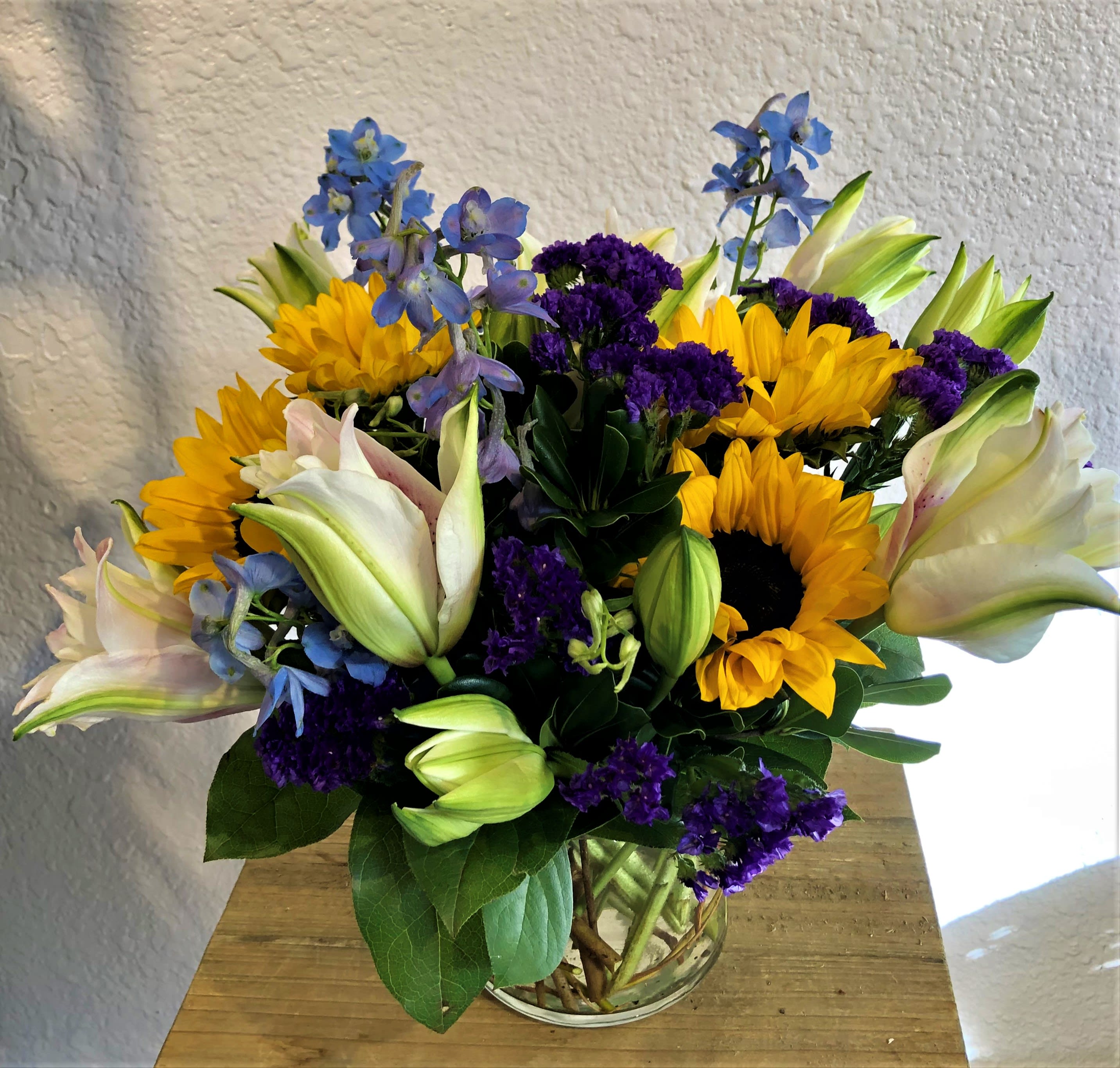 Gracie! Gracie! - Rose lilies, sunflowers, delphenium, and dusty miller arranged beautifully!