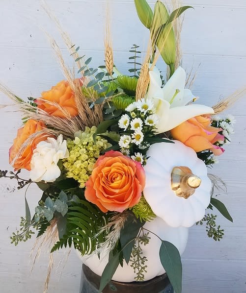 Enchanting Pumpkin - A bountiful white ceramic pumpkin filled with white, green and orange blooms accented by fall foliage. 