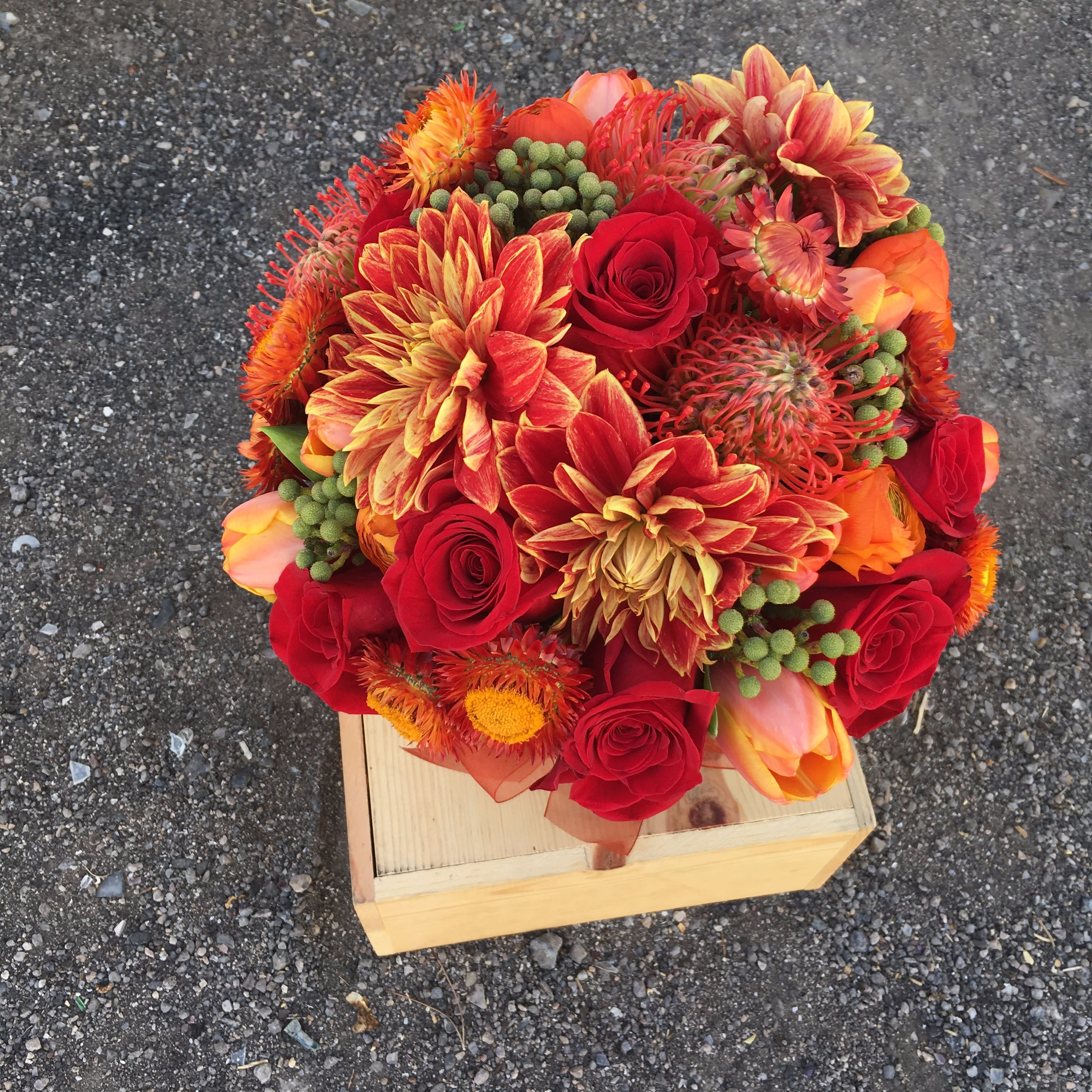 Maple French Toast - This red toned designer's choice arrangement is perfect for any occasion! The arrangement may include roses, dahliahs, tulips, touches of greenery and other beautifully toned elements fresh from the Miss Daisy cooler!   *It's possible that some days we may not have the exact flowers depending on the season, or exact container specified on the arrangement's description. When this is the case, our bouquets are made with flower substitutions or delivered in a different vase than expected by using substitutions of an equal or higher value. If you'd prefer no substitutions, please send an email or call us after placing your order. Please give us at least three days notice if you're looking for an arrangement with no substitutions.  Substitution Policy  In some instances, the florists photo may represent an overall theme or look and include a one-of-a-kind vase which cannot be exactly replicated. Although the actual bouquet may not precisely match the photo, its temperament will. Occasionally, substitutions of flowers or containers happen due to weather, seasonality and market conditions which may affect availability. If this is the case with the gift you've selected, the local florist will ensure that the style, theme and color scheme of your arrangement is preserved and will only substitute items of equal or higher value.