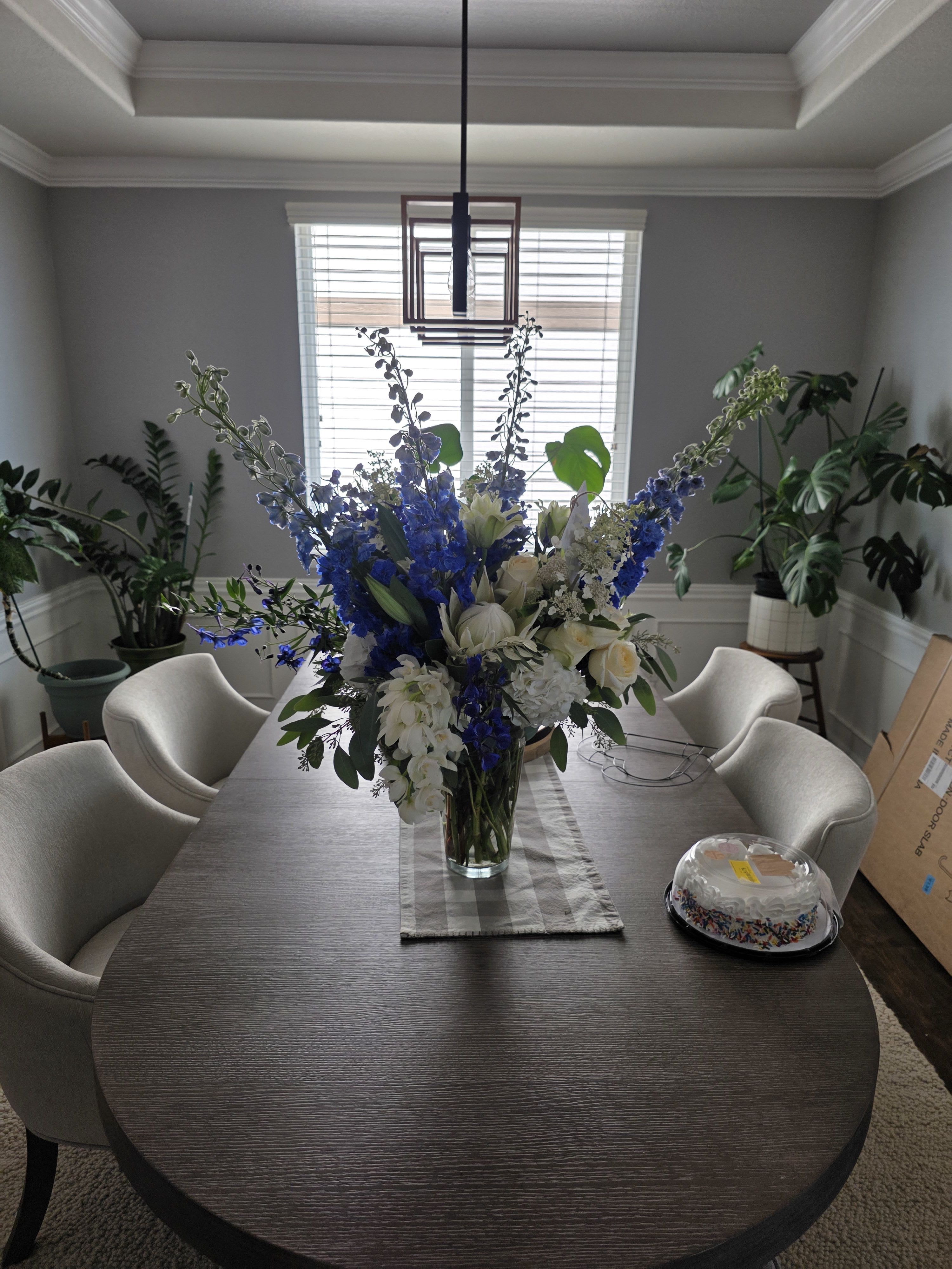 Royal Blue &amp; White Grande Arrangement - Royal Blue &amp; White Grande Arrangement Commanding attention with its striking palette, this luxurious arrangement blends royal blue and pristine white blooms in a breathtaking display. Standing approximately 4 feet tall and 3 feet wide, it makes a dramatic statement for any special occasion.  Please note: Flower varieties may vary based on seasonal availability, but we guarantee it will be abundantly full, impressively large, and absolutely gorgeous. 