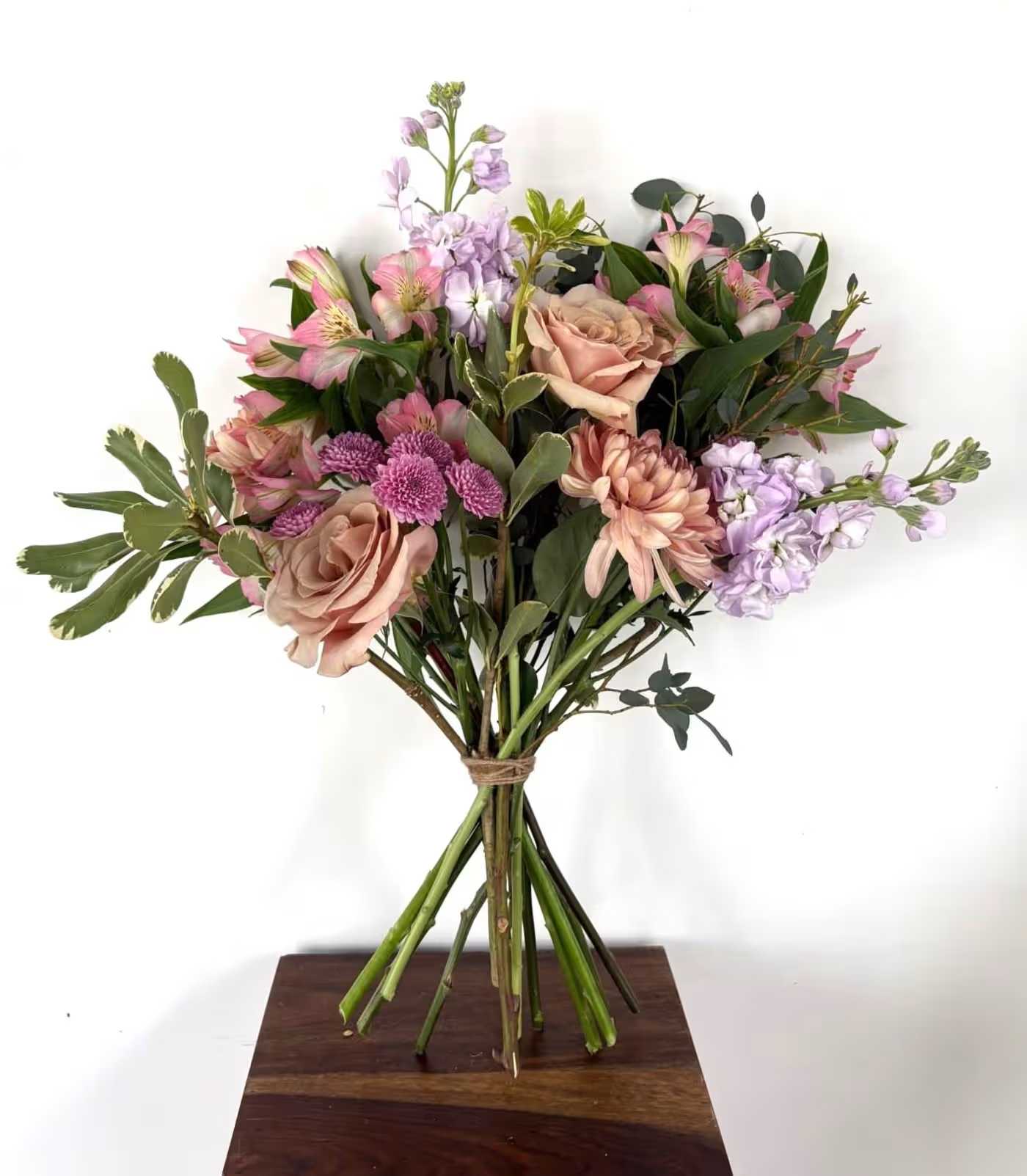 European Handtie Bouquet European Handtie Bouquet - A seasonal color mix of designer’s choice blooms, Spring color with grasses and local fillers, according to corresponding season