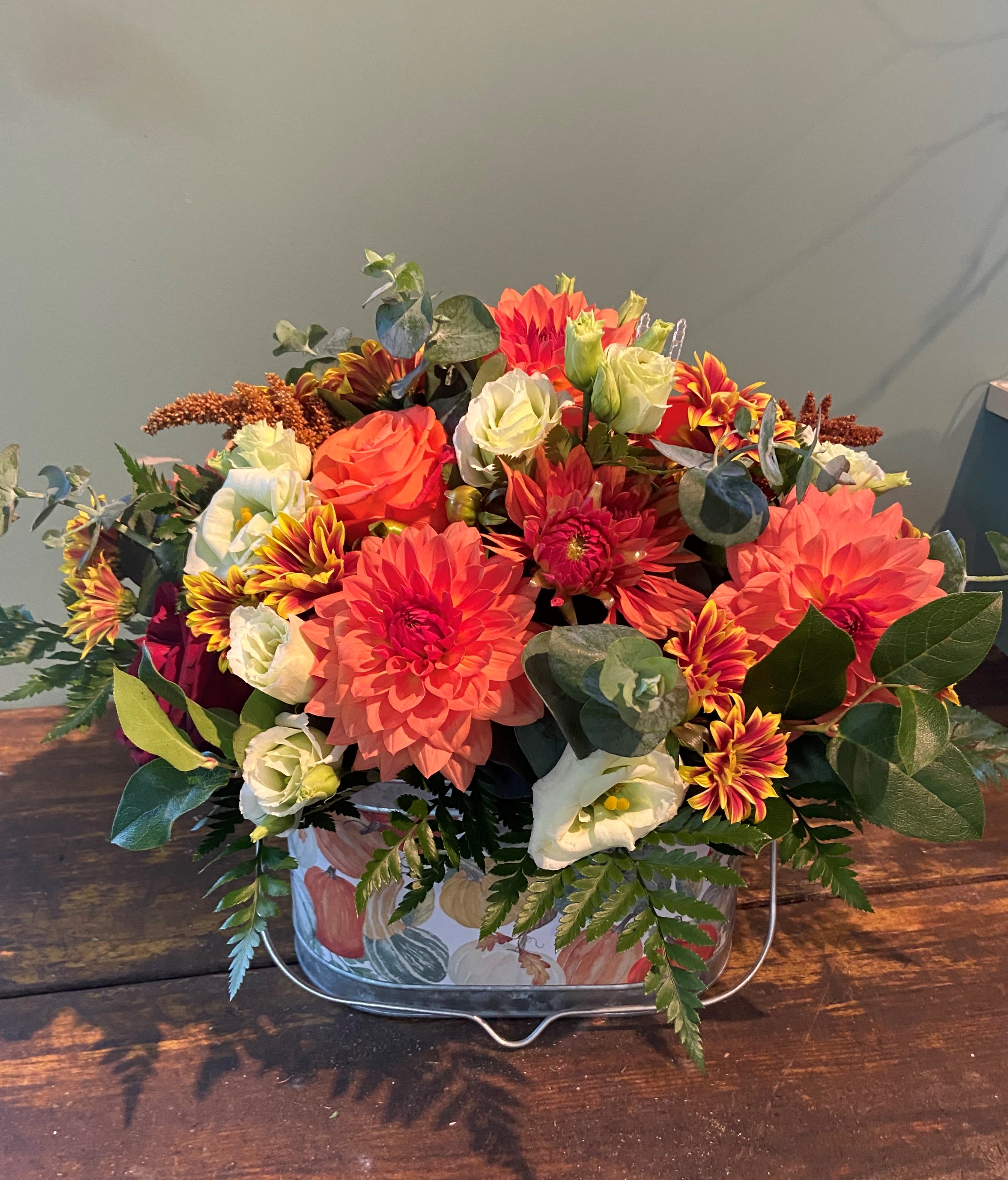 Pumpkin Spice - A beautiful autumn themed oblong or rectangular tin, rustic wooden box, or premium rustic basket , filled with an incredible Designer chosen selection of fall colored blooms.  Designer will choose container based on seasonality and availability. Item is oblong/rectangular in presentantion.   Entire item is approximately 14&quot;H x 14&quot;L x 9&quot; W.