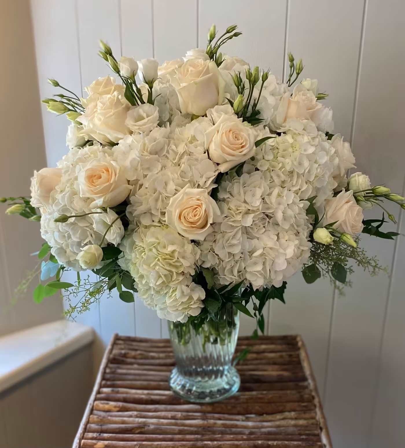 Cloud Nine Cloud Nine - A dreamy arrangement of lush white hydrangea's, ivory roses, and soft seasonal blooms. This timeless arrangement brings sophistication into any space