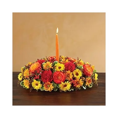 Autumn Wishes Centerpiece - All-around centerpiece arrangement with red carnations and hypericum; circus or bi-color orange roses; autumn-colored daisy poms; yellow Viking poms; accented with red painted solidago and assorted greenery Includes a 12&quot;L orange taper candle (overall dimensions do not include candle) Large arrangement measures