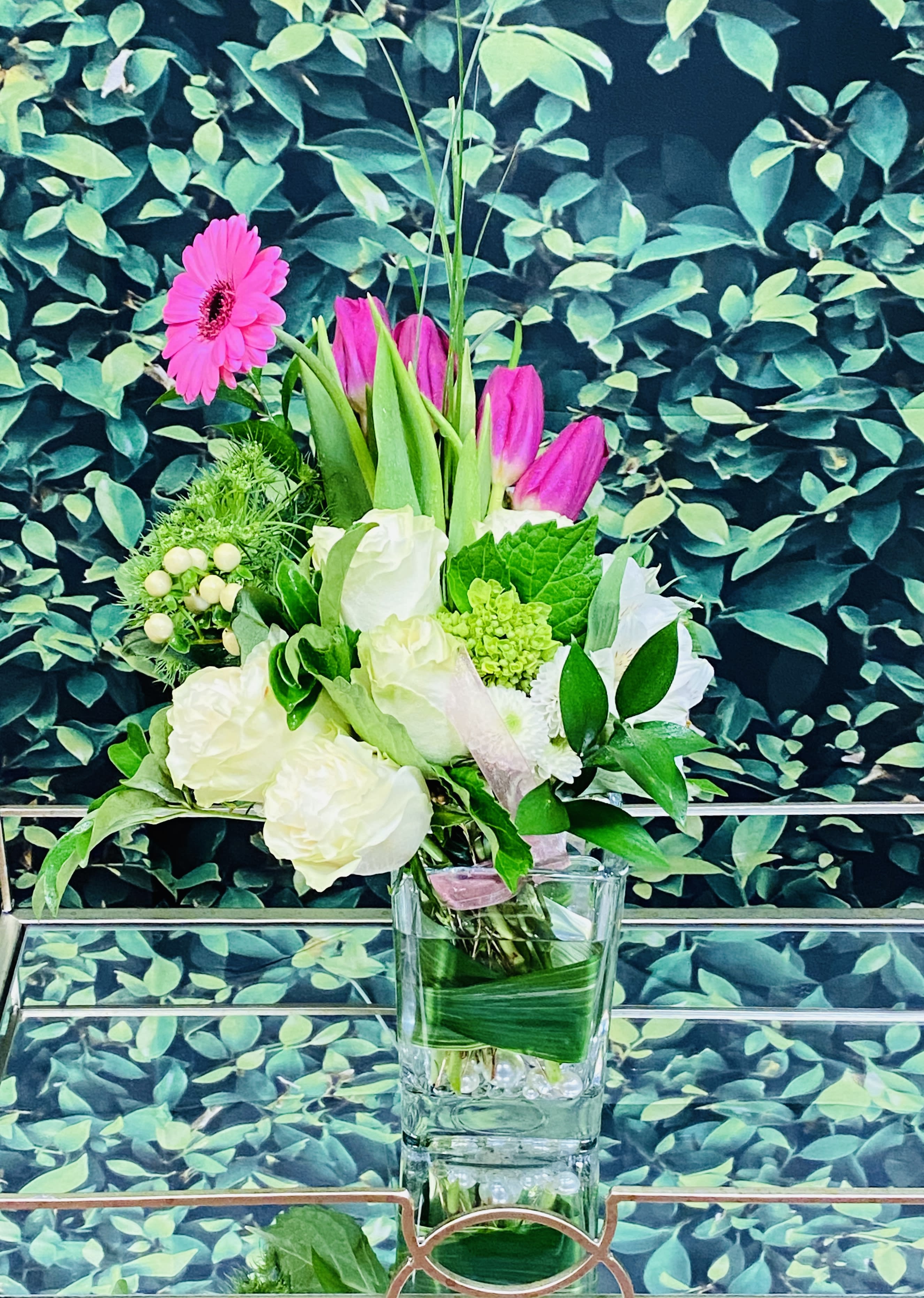Brighter Days by Donya's Florals, St. Augustine - Brighter Days is filled with gorgeous white roses, *fresh tulips, and cascading gerbera daisies for the person needing love, light, joy, or encouragement. Vase tealight renders a soft glow in the evenings.   *Tulips or another seasonal floral