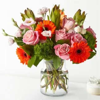 Audrey  - Home is where the heart is, especially when you fill it with these roses and gerbera daisies. Fresh flower arrangement along fine foliage. Bloom Details: Gerbera Daisy, Rose Clear Vase  Place your Order Online Monday to Saturday before 1:00 p.m. (E.T.) for same-day delivery.  “Orders received after hours will be delivered the next business day”. Check our coverage area.  Occasionally, substitutions of flowers and/or containers happen due to weather, seasonality, and market conditions which may affect availability. If this is the case with the gift you’ve selected, we will ensure that the style, theme, and color scheme of your arrangement are preserved and will only substitute items of equal value or higher value.   CARE INSTRUCTIONS	 Keep the flower arrangement hydrated with natural water and change the water every two days. Do not spray any cleaning product on the flower arrangement. Do not place heavy objects directly on the flower arrangement. Keep flower arrangements out of direct sunlight and extreme heat. 