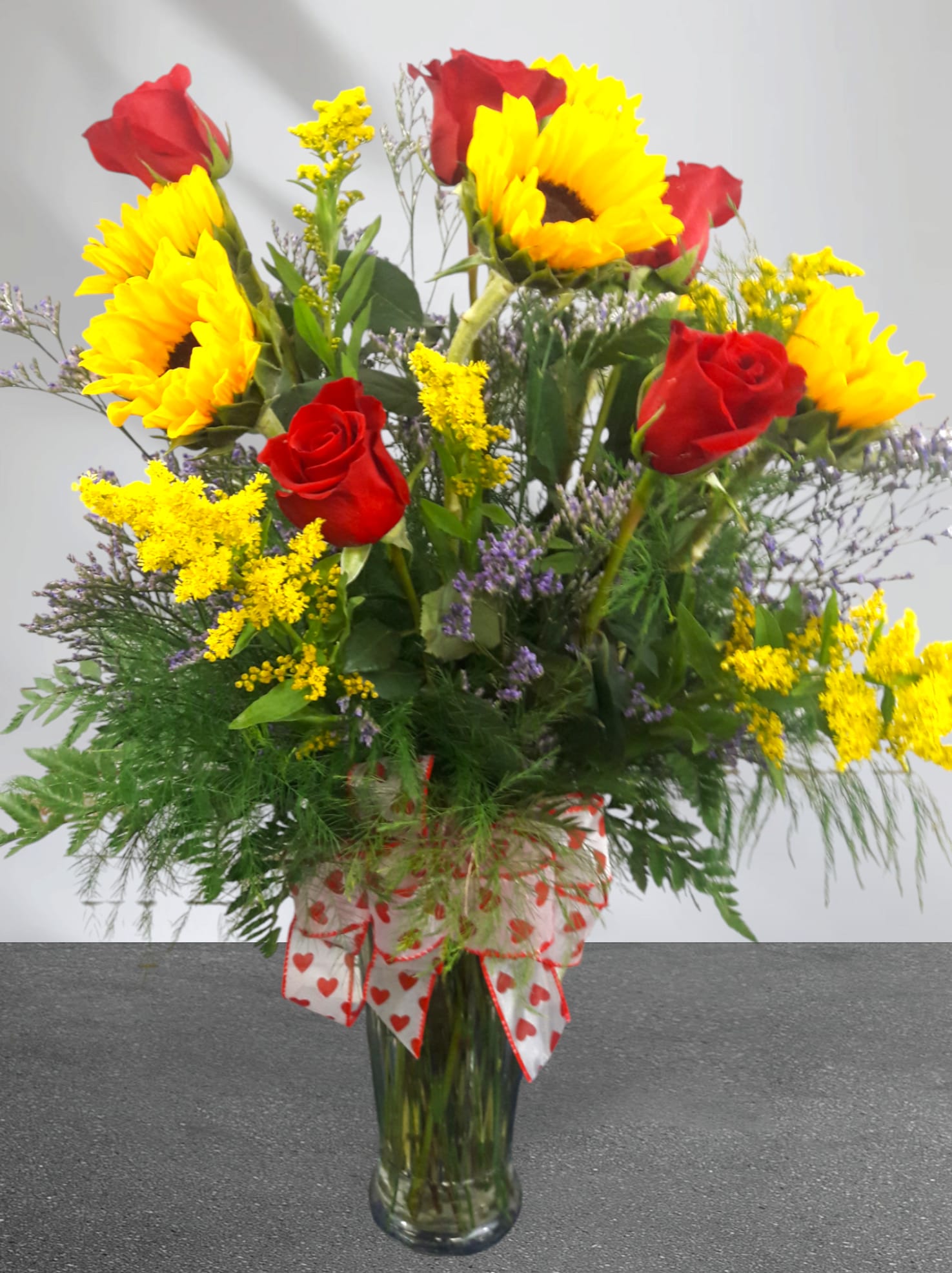 LOVE and SUNSHINE  - Nothing says I will love you forever like our LOVE and SUNSHINE bouquet.  *Sunflowers symbolize adoration, loyalty and longevity.  *Red Roses symbolize romance and passion.   Standard: 6 Red Roses and 6 Sunflowers hand-crafted to order, with an accent flower, and greenery in a vase.   Premium: 12 Red Roses and 6 Sunflowers hand-crafted to order, with an accent flower, and greenery in a vase. (PICTURED AS A PREMIUM BOUQUET)   Accent Flowers May Include one or more of the following: Babies Breath, Limonium, Caspia, Solidago