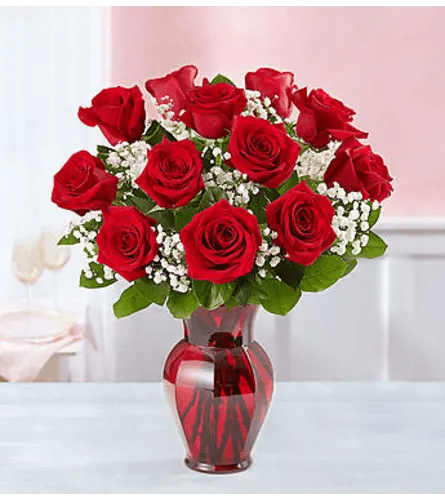 Classic 12 Red Roses Classic 12 Red Roses - 12 Classic Red Roses Deluxe All Occasion Red Glass Vase Place your Order Online Monday to Saturday before 1:00 p.m. (E.T.) for same-day delivery. “Orders received after hours will be delivered the next business day”. Check our coverage area. Occasionally, substitutions of flowers and/or containers happen due to weather, seasonality, and market conditions which may affect availability. If this is the case with the gift you’ve selected, we will ensure that the style, theme, and color scheme of your arrangement are preserved and will only substitute items of equal value or higher value. CARE INSTRUCTIONS Keep the flower arrangement hydrated with natural water and change the water every two days. Do not spray any cleaning product on the flower arrangement. Do not place heavy objects directly on the flower arrangement. Keep flower arrangements out of direct sunlight and extreme heat.