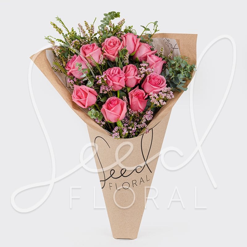 I Heart You DZ Rose Bouquet - Pink - A gorgeous wrapped bouquet designed with premium 1 Dozen Pink Roses, Wax Flower and Eucalyptus.   **UPGRADE OPTIONS** STANDARD - I Heart You Bouquet  DELUXE - I Heart You Bouquet + Moonstruck Chocolate Bar PREMIUM - I Heart You Bouquet + Moonstruck Chocolate Bar + Soy Candle (assorted scents) 