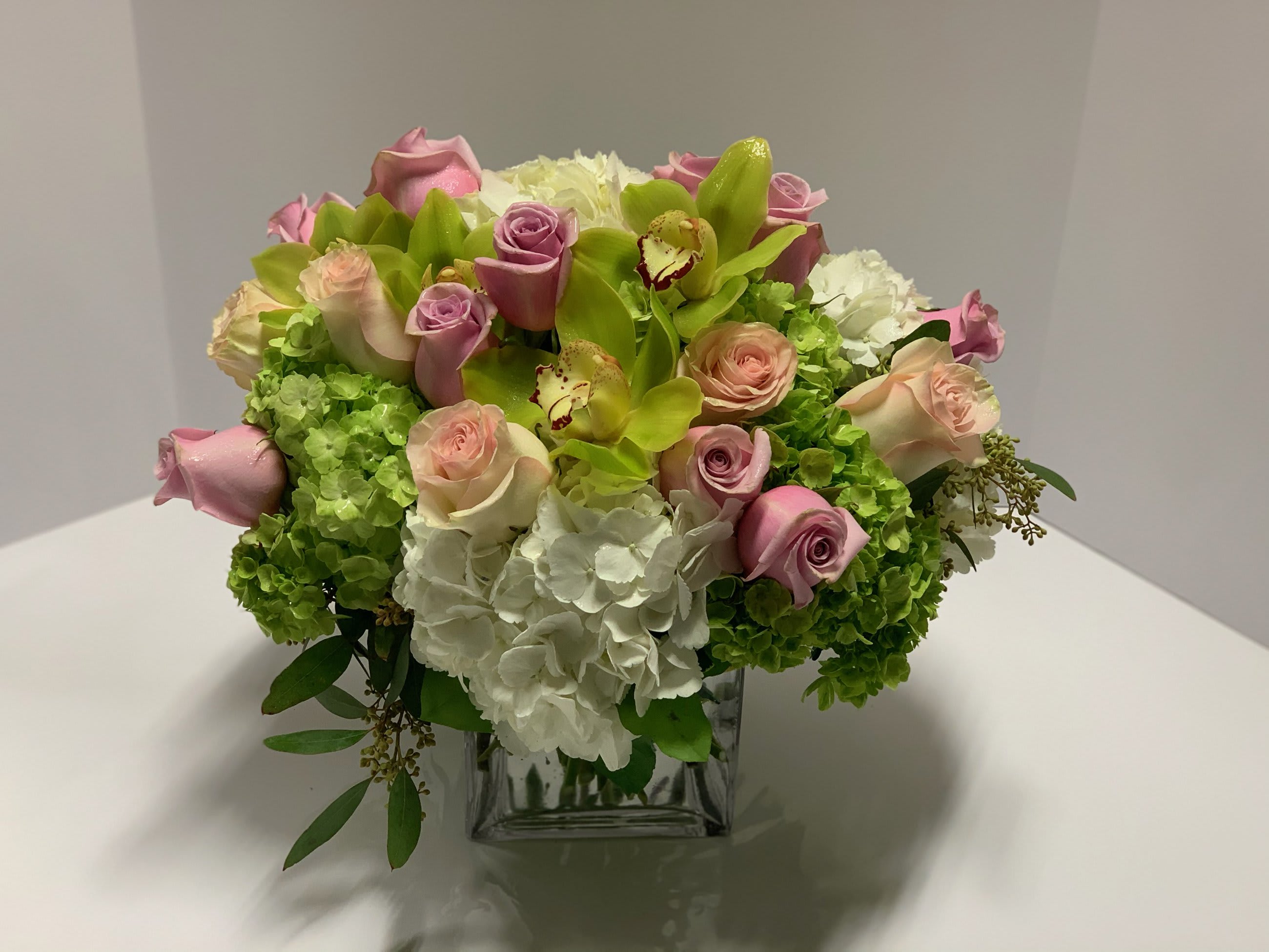 Forever Love Forever Love - An array of pastels!  Hydrangea, roses and orchids in a large cube. Approximately 17x17