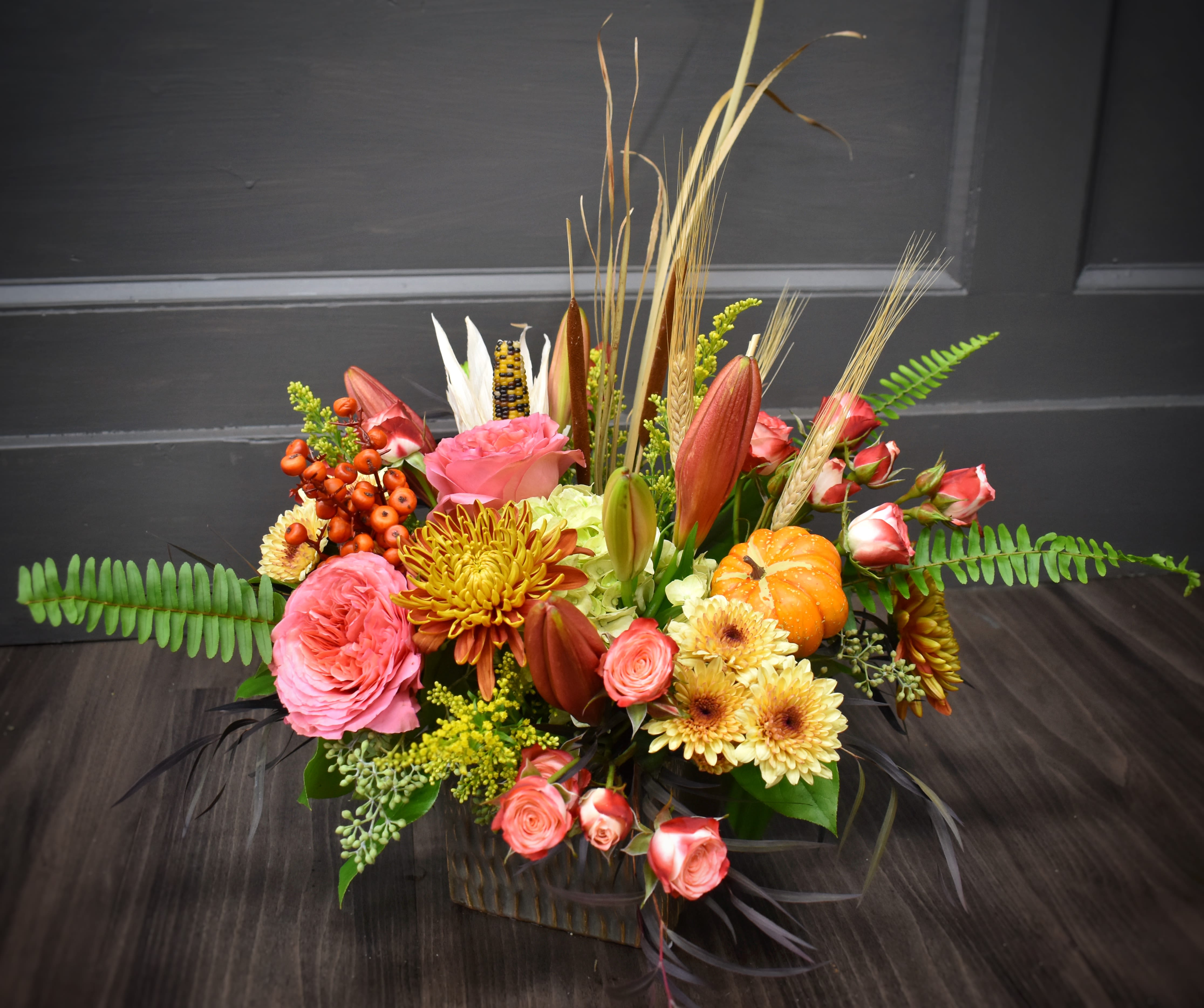 Premium Country Roads - Country Roads take me home! A lovely autumn arrangement to send to a loved one or someone in need of a pick-me-up. Our most elegant edition that includes premium roses and spray roses.