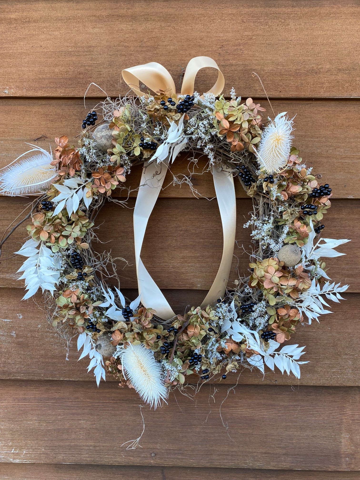 Dried Floral Wreath 2 - 16&quot; - 1 available - 16&quot; grapevine wreath with dried &amp; tinted hydrangea, dried &amp; tinted thistle, blackberry lily pods, bleached &amp; dried ruscus, German statice, sphagnum moss, satin ribbon.