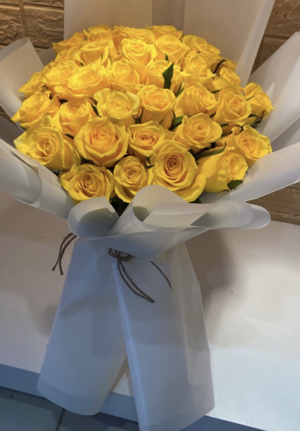 Yellow roses bouquet  - Yellow roses always harmonize wherever they go, since their color emanates happiness, love, friendship, but above all, joy. Available in standard (two dozen roses), deluxe (four dozen roses), and premium (four dozen roses plus five sunflowers).