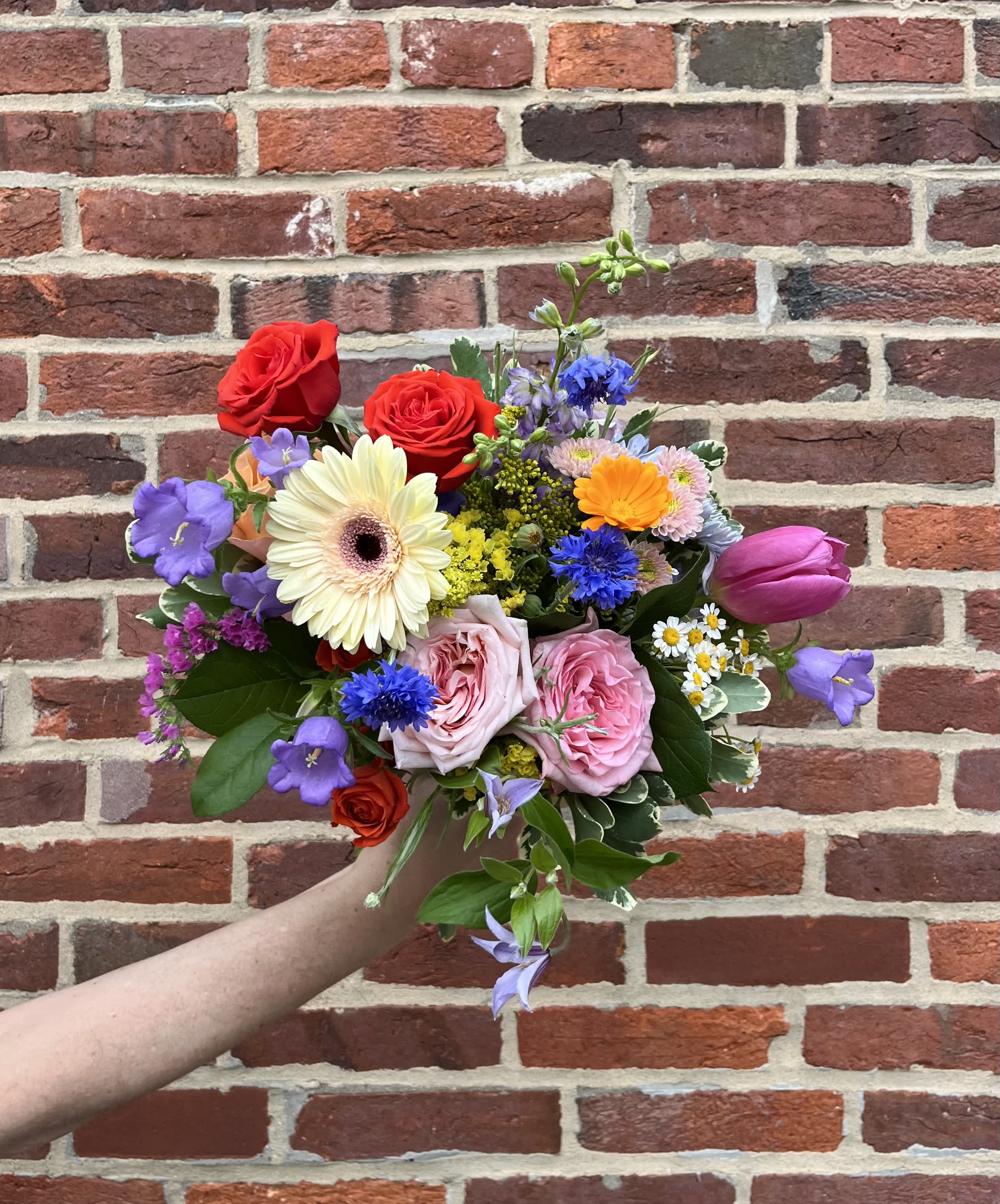 DESIGNER'S CHOICE WRAPPED ARRANGEMENT - Allow our talented team of designers to choose the freshest and most inspired blooms to &quot;wow&quot; you and the recipient with a colorful bouquet. Notes welcome. Actual flowers will vary due to availability. 
