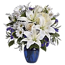 Beautiful in Blue - In this arrangement, the serenity of the color blue along with the purity of intention symbolized by white will let the family know you are sending your calm strength to them during these difficult times  Orientation One-Sided  Dimensions 16 1/2 W x 18 H