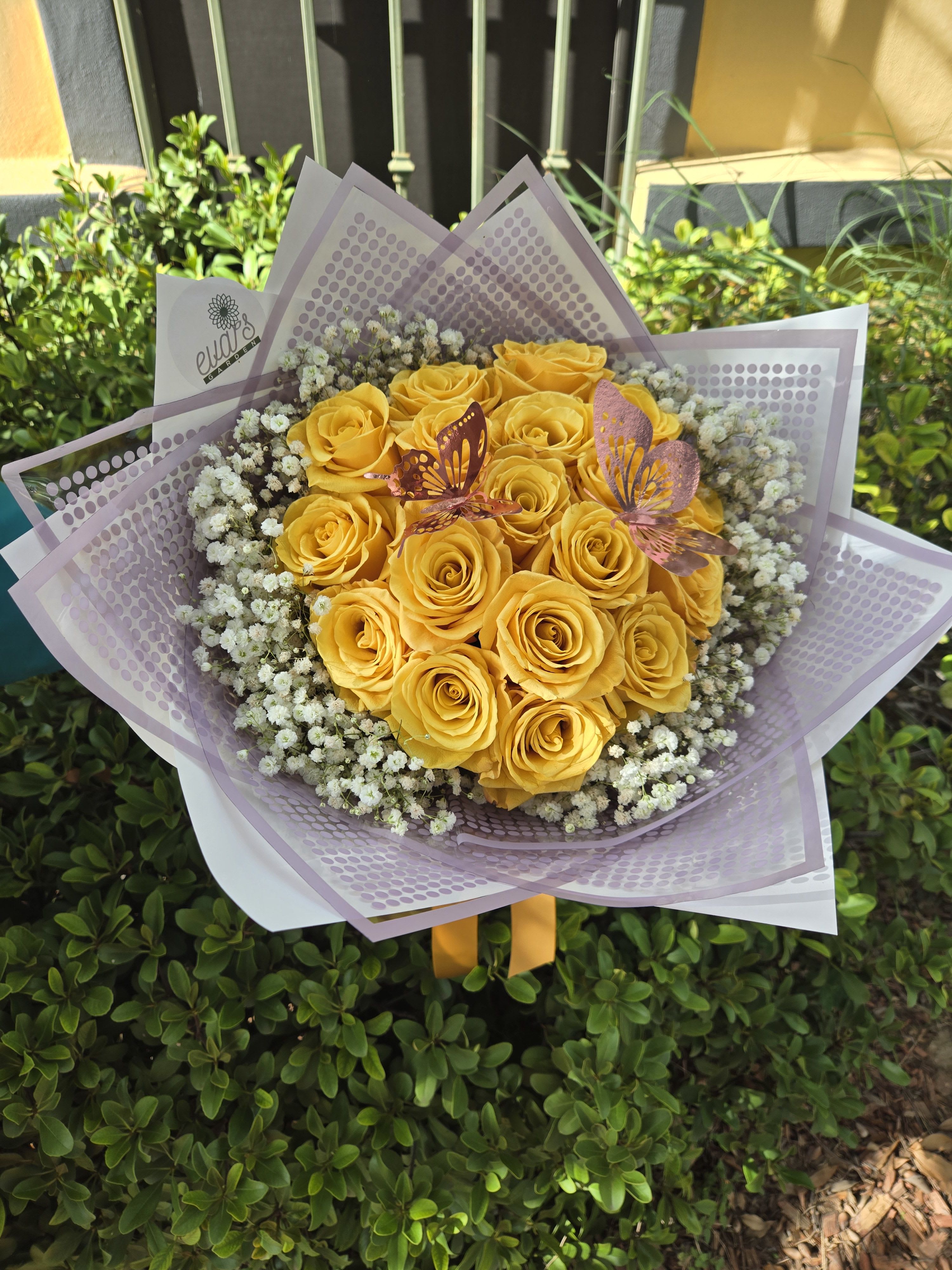 My Golden Hour - Beautiful bouquet with 18 yellow roses, 2 golden butterflies, and various stems of baby's breath. This bouquet is wrapped in floral wrapping paper. 