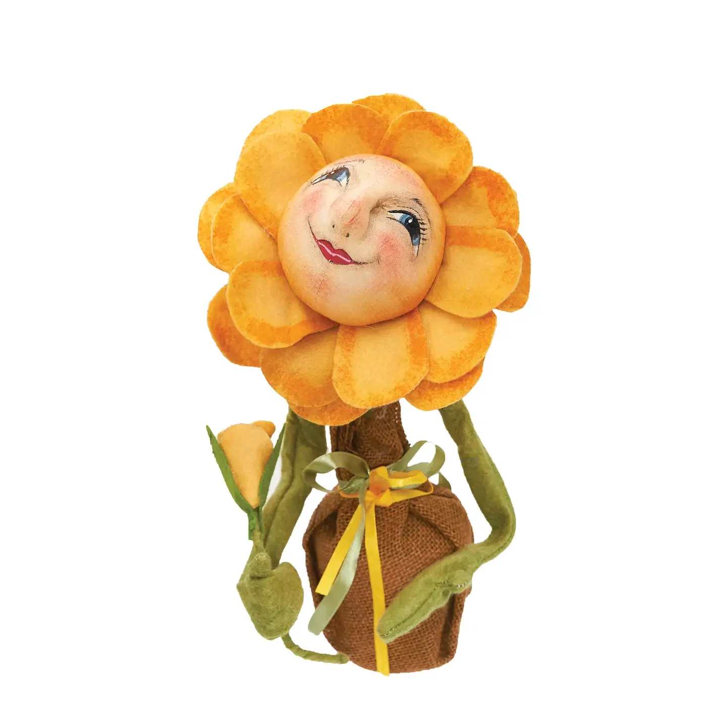 Buttercup Sunflower Buttercup Sunflower - Buttercup Sunflower is hand-painted with big blue eyes and a smiling face. Soft yellow petals frame her expressive face, and she sits in a weighted burlap pot. Whimsically wonderful, this uniquely handcrafted figurine from Joe Spencer's Gathered Traditions' collection will bring a charming touch to your home. Create your own flower collection by adding our Blossom Sunflower and Poppy Sunflower