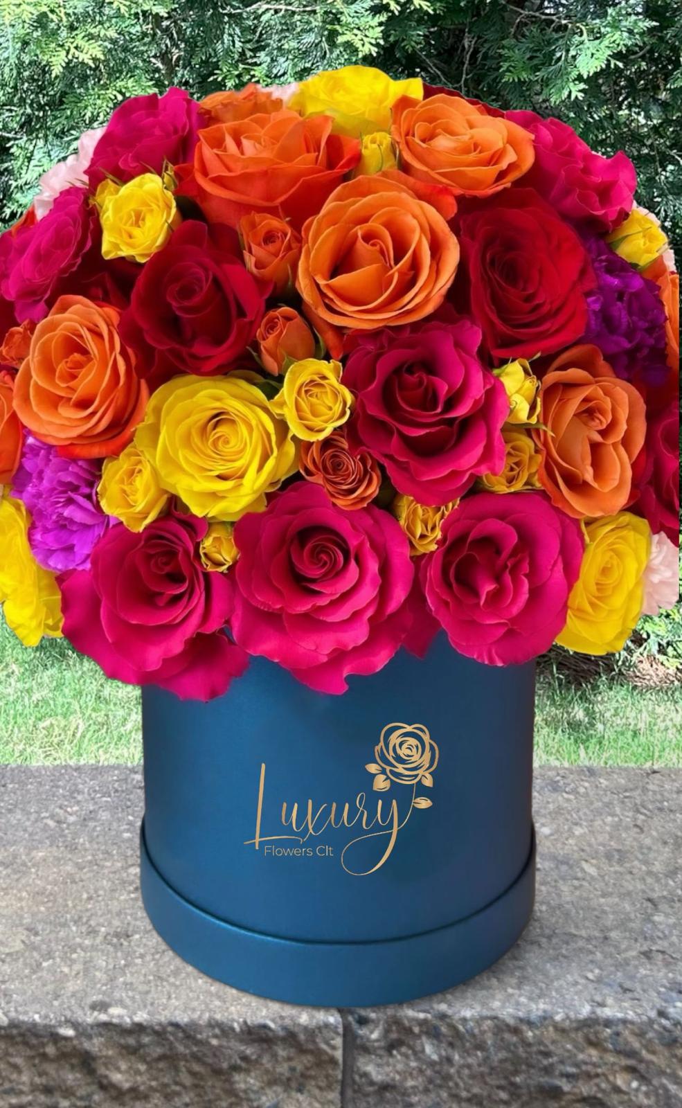 Color Power Box - &quot;PLACE YOUR ORDER AT LEAST 2 DAYS PRIOR TO THE DELIVERY DATE”  Beautifully crafted colorful fresh flowers are a true symbol of joy and color.  All Occasion. Roses in Box: 50-55 stems of natural roses. 6” Black Cylinder Contaiber Check our coverage area.  Place your Order Online Monday to Saturday before 1:00 p.m. (E.T.) for same-day delivery.  “Orders received after hours will be delivered the next business day”. Check our coverage area. Occasionally, substitutions of flowers and/or containers happen due to weather, seasonality, and market conditions which may affect availability. If this is the case with the gift you’ve selected, we will ensure that the style, theme, and color scheme of your arrangement are preserved and will only substitute items of equal value or higher value.  CARE INSTRUCTIONS Gently mist the arrangement with natural water every other day. Do not spray any cleaning product on the flower arrangement. Do not place heavy objects directly on the flower arrangement. Keep them out of direct sunlight and extreme heat.  
