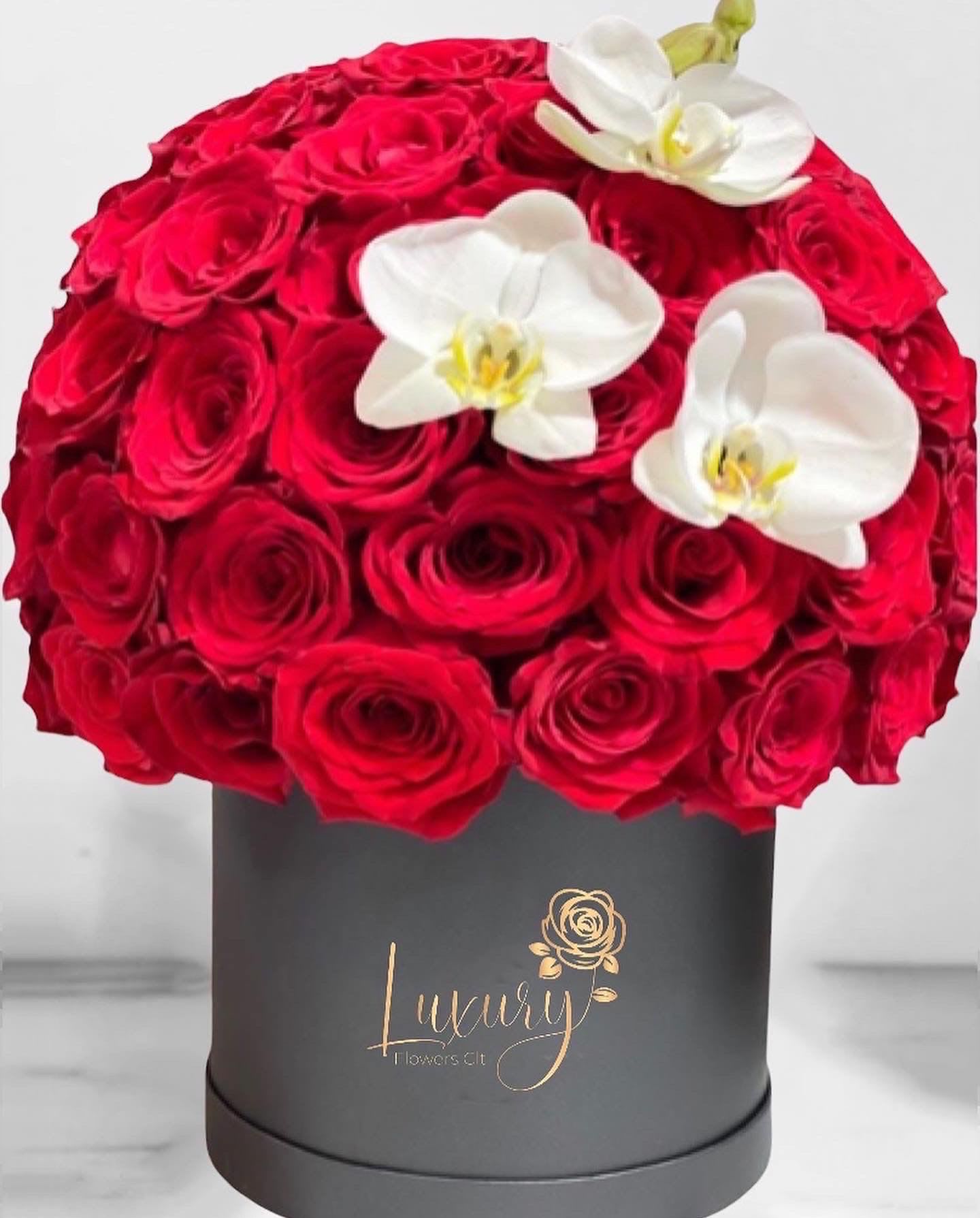 Eternal Love  - &quot;PLACE YOUR ORDER AT LEAST 2 DAYS PRIOR TO THE DELIVERY DATE”  Our luxury roses box crafted are the true symbol of elegance and good taste. This beautiful arrangement speaks for itself!  Approximately 55-60 stems of natural red roses with an elegant orchid 6” White or Black  Cylinder Container (subject to inventory availability) Check our coverage area.  Place your Order Online Monday to Saturday before 1:00 p.m. (E.T.) for same-day delivery.  “Orders received after hours will be delivered the next business day”. Check our coverage area.  &quot;Occasionally, substitutions of flowers and/or containers happen due to weather, seasonality, and market conditions which may affect availability. If this is the case with the gift you’ve selected, we will ensure that your arrangement's style, theme, and color scheme are preserved and will only substitute items of equal value or higher value&quot;.  CARE INSTRUCTIONS Gently mist the arrangement with natural water every other day. Do not spray any cleaning product on the flower arrangement. Do not place heavy objects directly on the flower arrangement. Keep them out of direct sunlight and extreme heat. 
