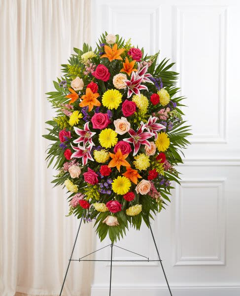 Bright Standing Spray Bright Standing Spray - Standing spray arrangement with bright, mixed colors accented with soft, lush greenery