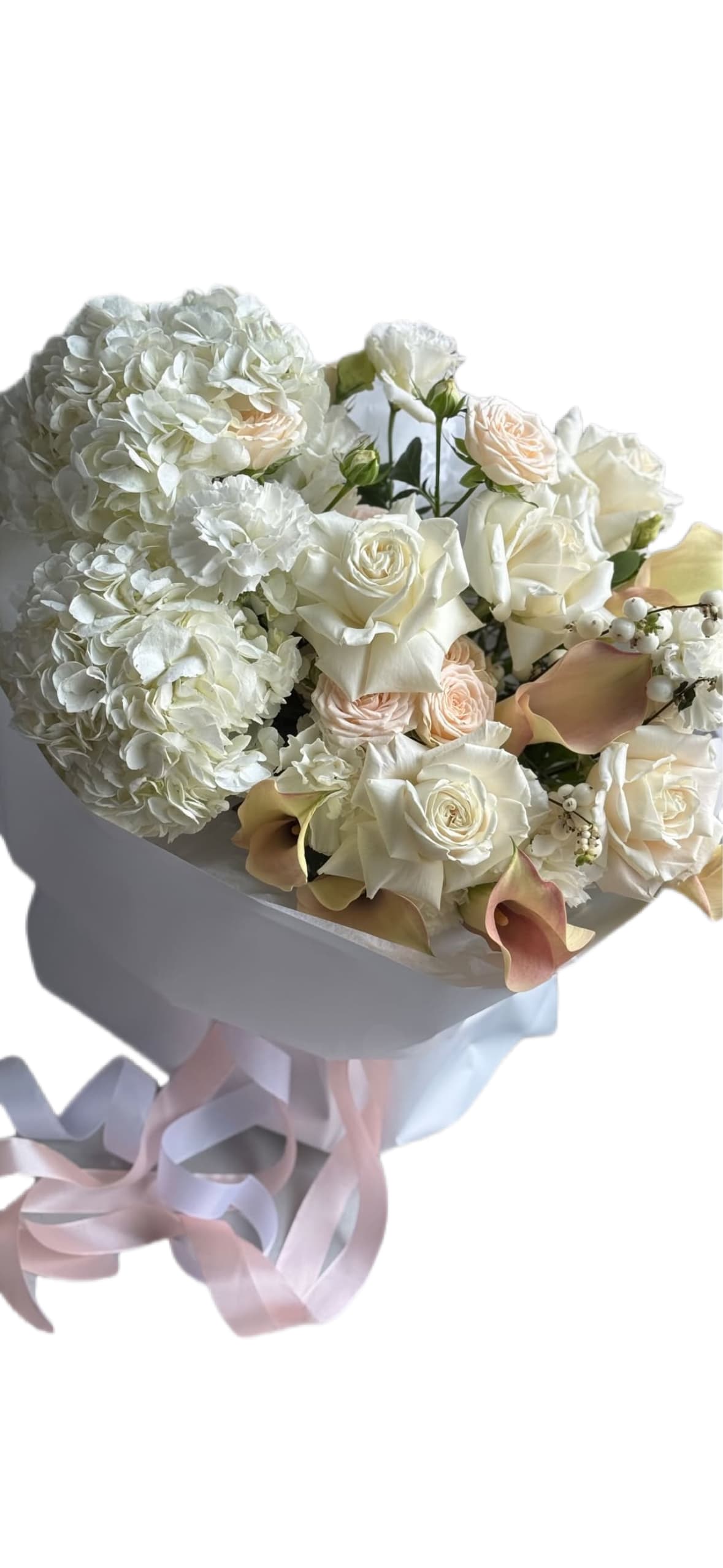 A White Symphony of Elegance - A White Symphony of Elegance  There is something truly timeless about a pure white bouquet. It is more than just an arrangement of flowers — it is a symbol of sincerity, grace, and the kind of love that speaks in quiet whispers. Our all–white bouquet with accents of white hydrangeas, calla lilies, and roses is a masterpiece of elegance designed to capture the essence of purity and refinement.  The soft, cloud–like petals of white hydrangeas create a lush, voluminous base, evoking a sense of serenity and calm. Their fullness represents abundance and heartfelt emotions, making them the perfect foundation for this composition.  Graceful calla lilies add a modern touch of sophistication. Their sleek, sculptural lines carry a deeper meaning — representing admiration, beauty, and devotion. Each bloom feels like a work of art, enhancing the bouquet with a striking yet gentle presence.  And of course, the timeless roses. White roses have always been a symbol of true love, innocence, and new beginnings. They weave into the bouquet with classic charm, adding layers of romance and depth. Together, these blooms create a flawless harmony — delicate yet powerful, minimal yet expressive. 