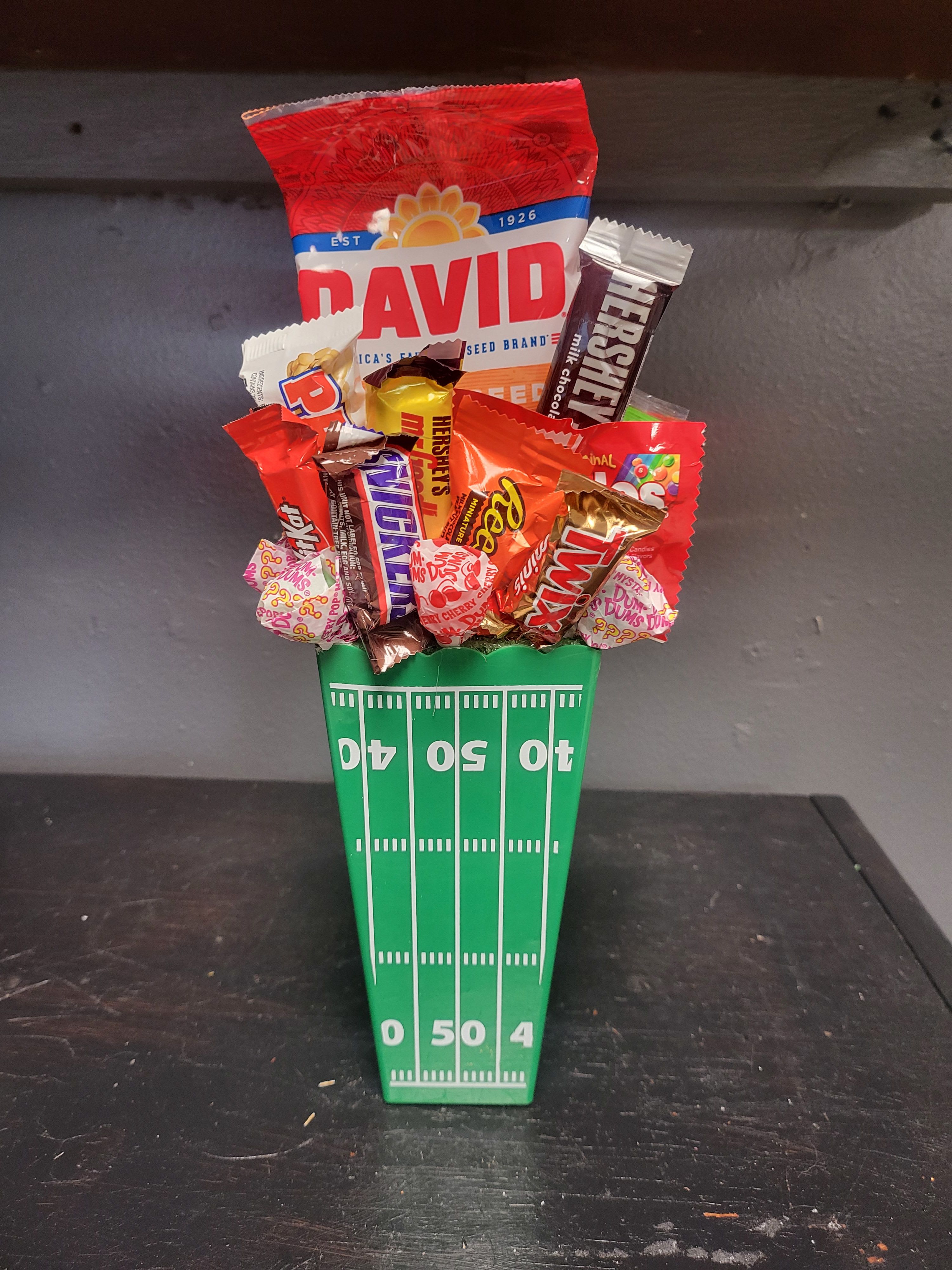 Team Spirit - All Way Candy Bouquet by Katherine's Flowers Team Spirit - All Way Candy Bouquet by Katherine's Flowers - Team Spirit - All Way Candy Bouquet is a great way to celebrate our Boys of Fall and show our local school spirit, also a nice Birthday Gift for that Football Lover Deliver Daily