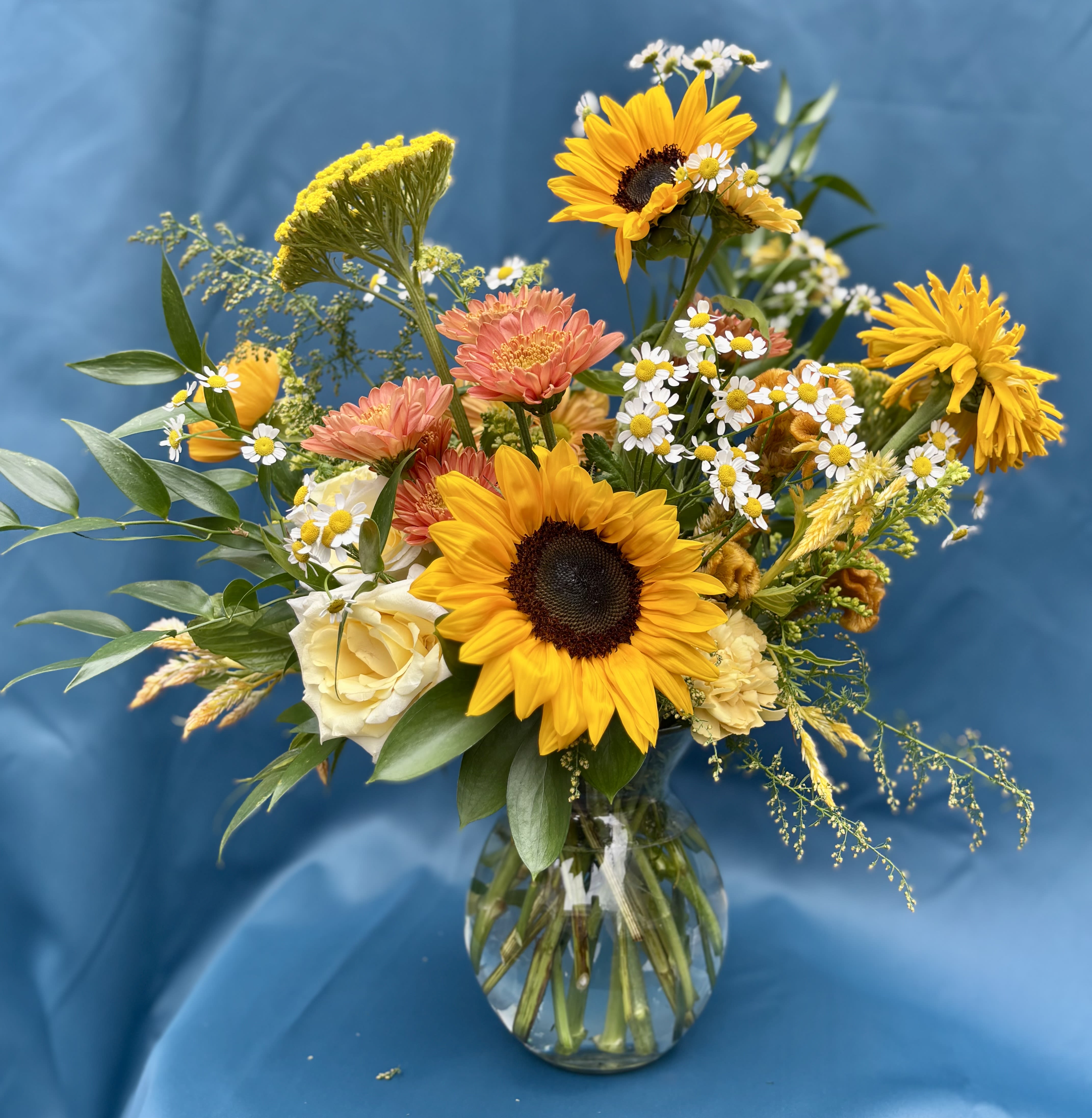 GOLD DUST VASED ARRANGEMENT - Golden yellows with pops of lemon, mustard, saffron and ochre are the highlights of this seasonal palette. Perfect for those who adore sunflowers. Exact florals are subject to availability, but the color palette will remain intact. 