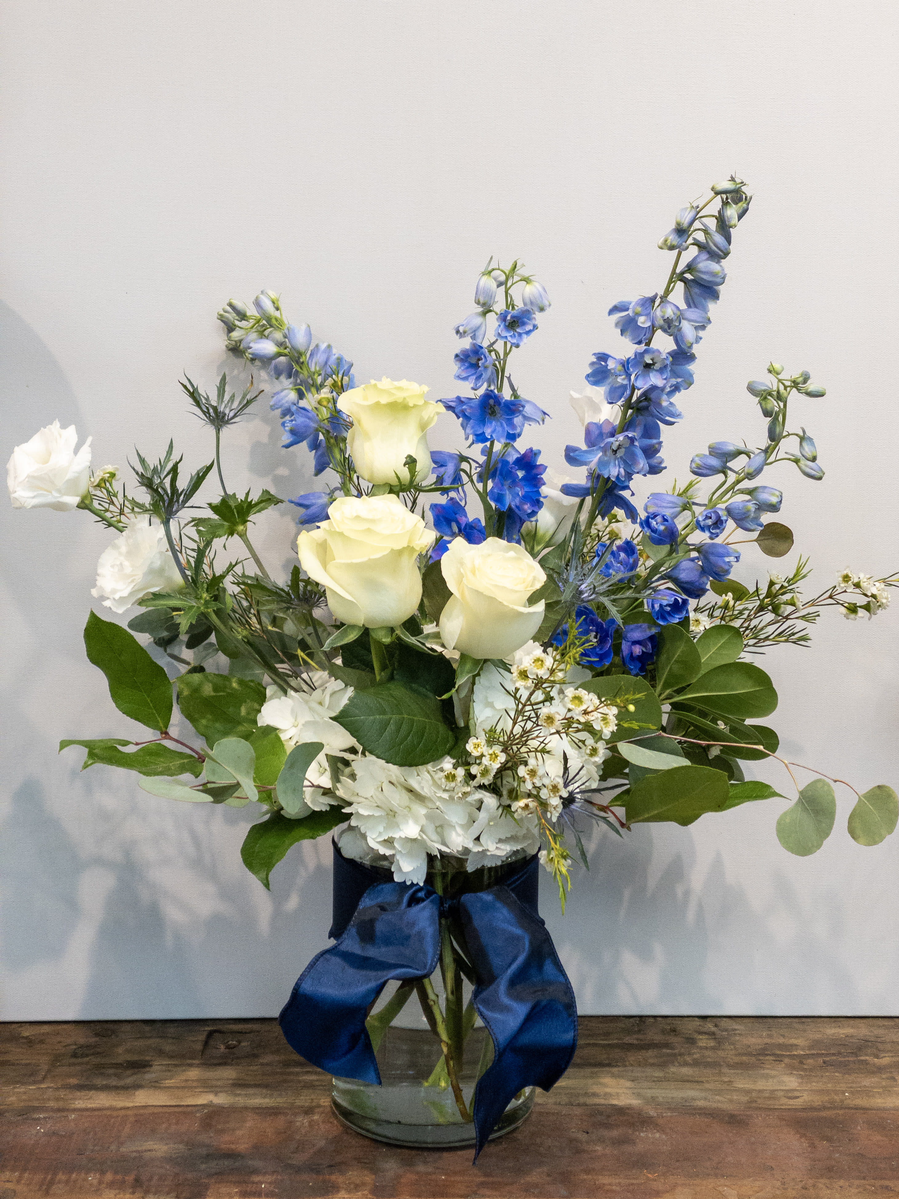 Blue Skies - A customer favorite, this arrangement contains a gorgeous mix of our freshest blue and white flowers.  Standard size measures approximately 10&quot; x 14&quot;. 