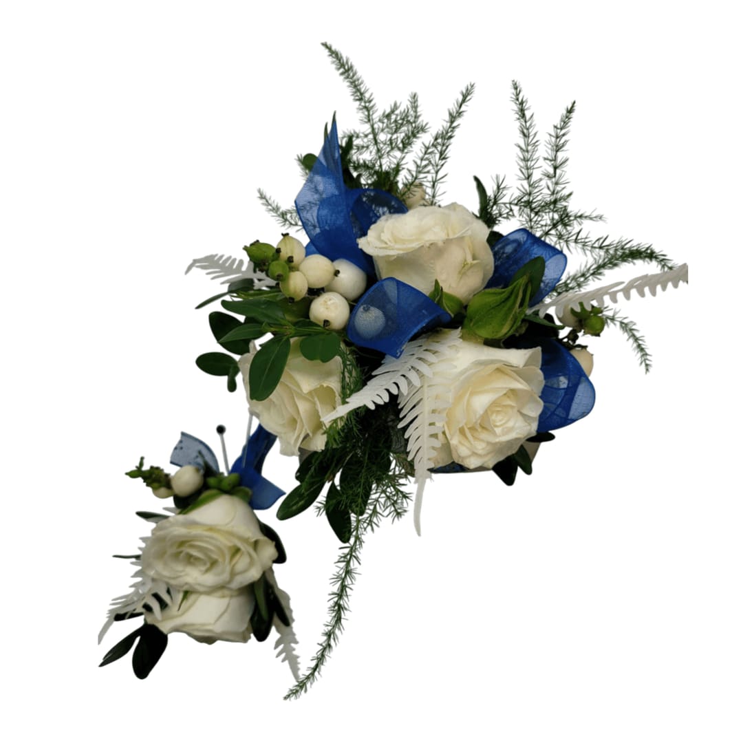 Blue and White Beaded Wrist Corsage and Boutonniere Set Blue and White Beaded Wrist Corsage and Boutonniere Set - This elegant bead bracelet wrist corsage and boutonniere set features a stunning combination of white roses, delicate greenery, and soft blue ribbon accents. The wrist corsage showcases a luxurious arrangement of white roses paired with sprigs of ferns, and vibrant green foliage. A coordinating blue ribbon and a touch of white fern create a harmonious, sophisticated design, perfect for formal occasions like weddings, anniversaries, proms or homecoming. The matching boutonniere is crafted with a white rose and similar floral elements, ensuring a cohesive look for the wearer and their partner.